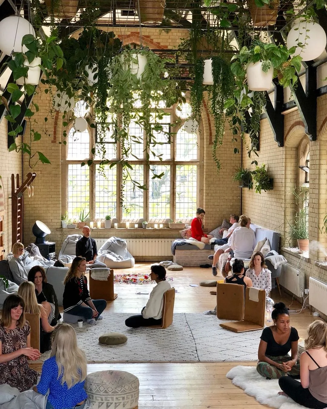 People sitting in a cozy space, reading and discussing together, symbolizing a Ginkgo book club gathering.