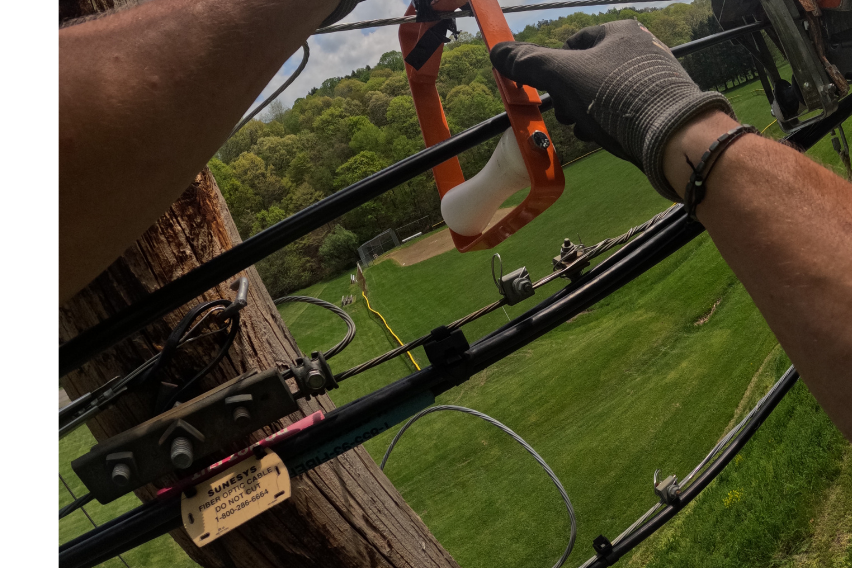 A pole tag and attachment hardware photographed during a field audit to verify what is attached and at what height.