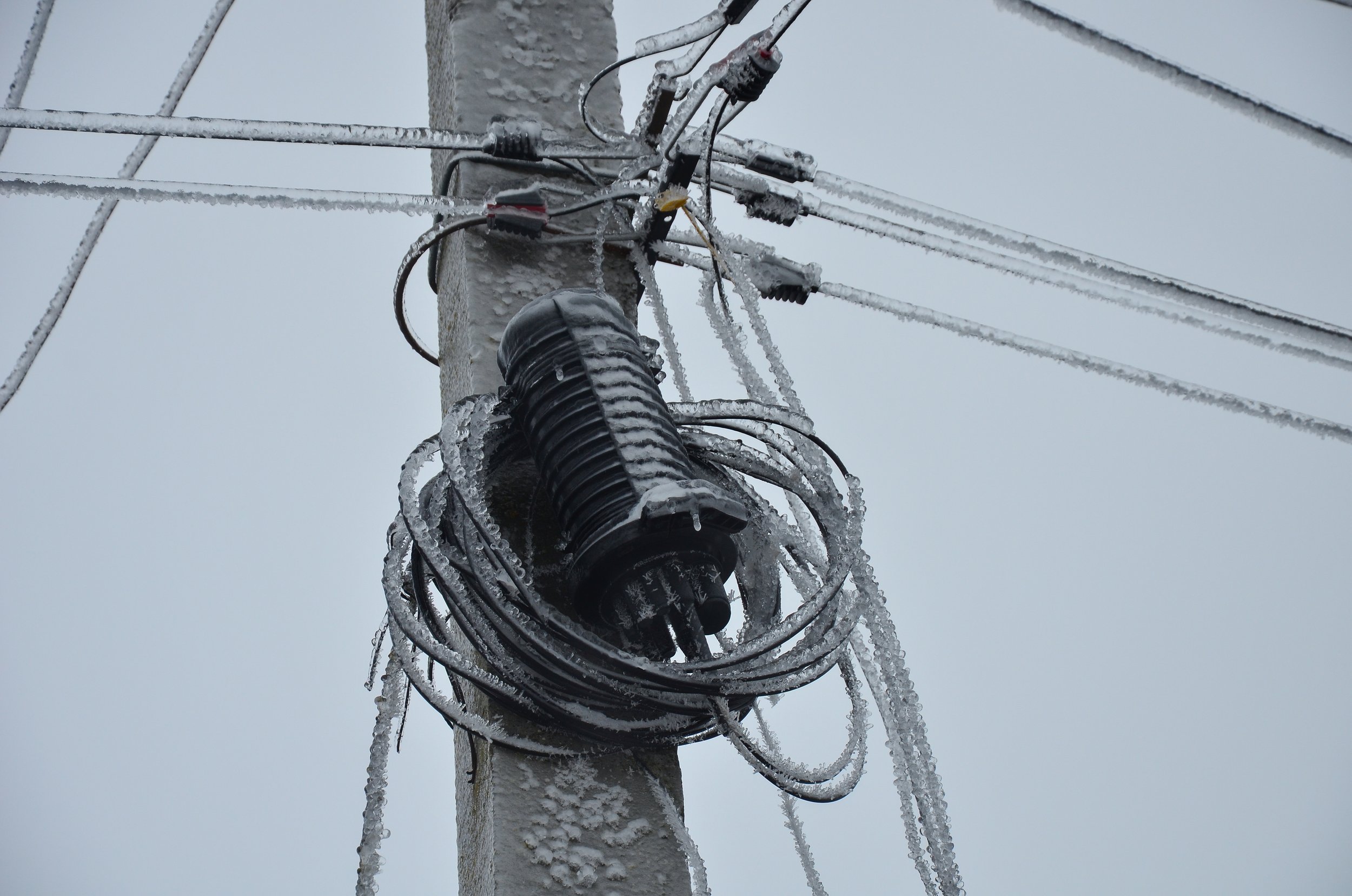 Utility pole with existing communications attachments awaiting make-ready engineering work