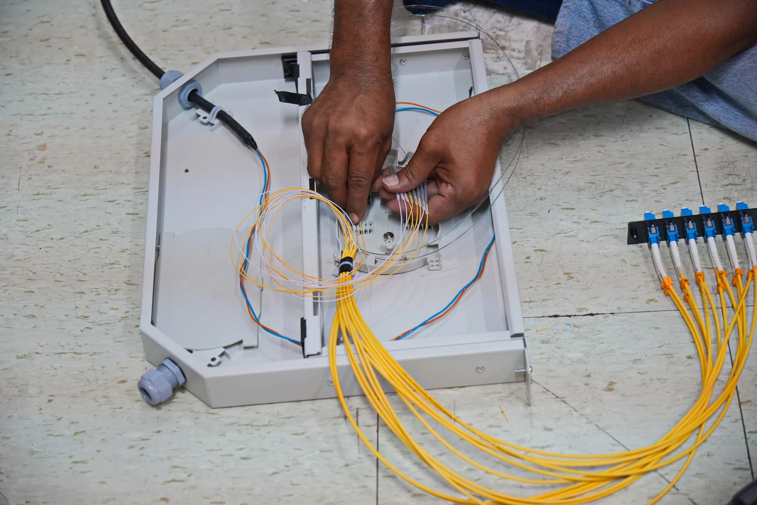 Open fiber optic splice enclosure showing splice trays and fiber routing that must be documented in as-built splice diagrams.