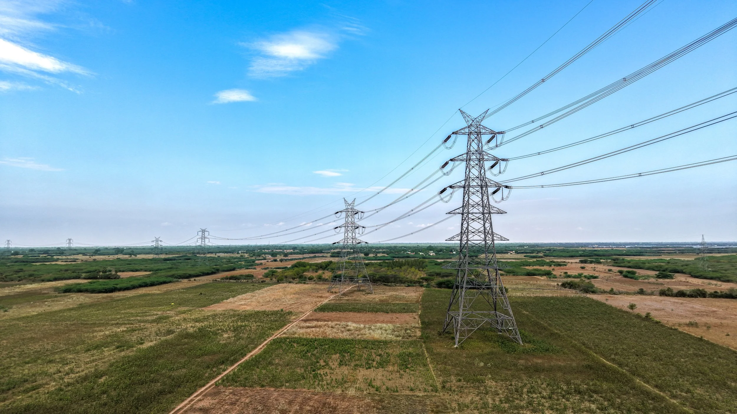 Optical ground wire OPGW installed at the top of a high-voltage transmission tower, serving as both lightning shield and fiber optic communication path.