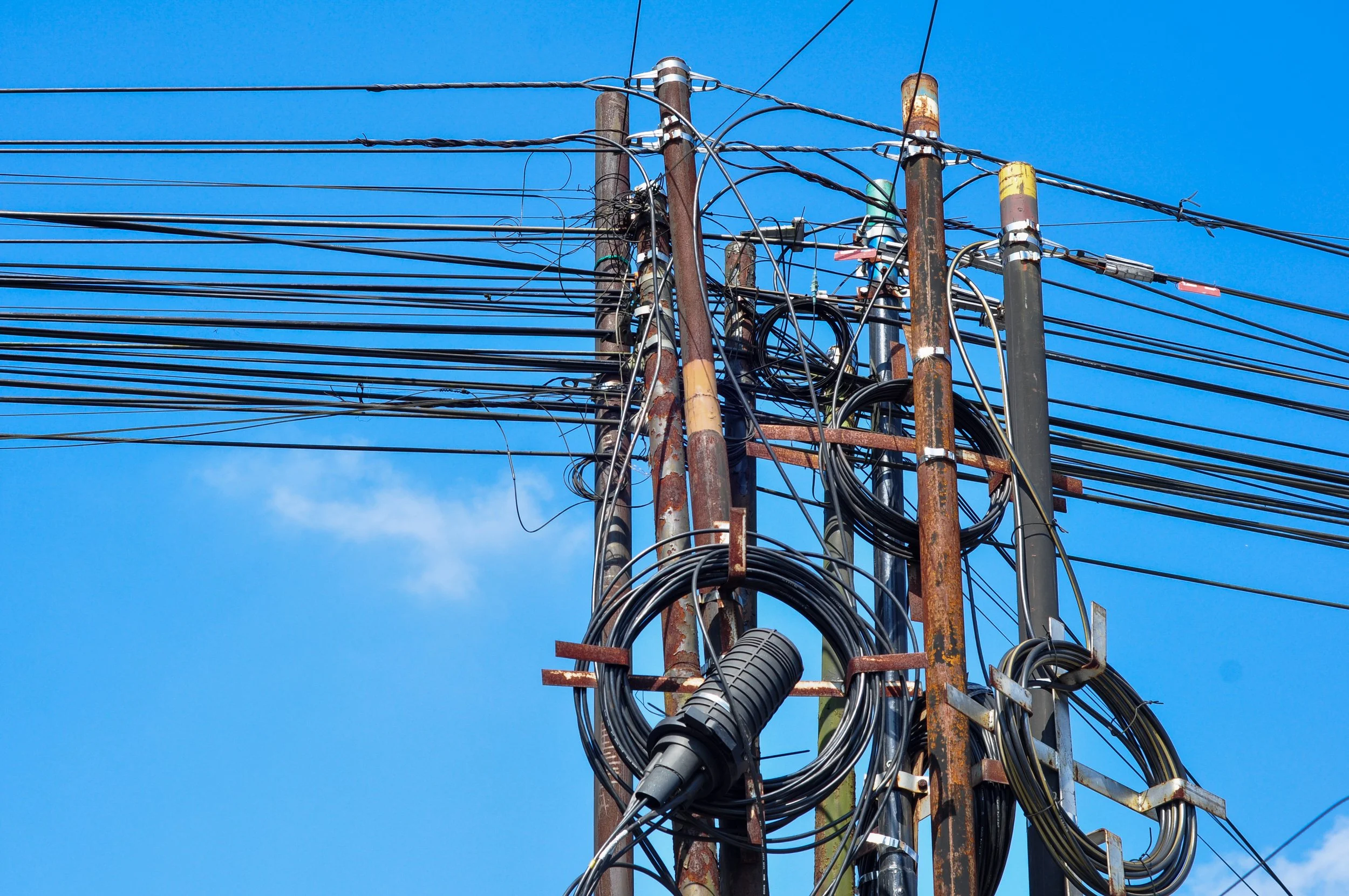 Utility pole with existing communications attachments awaiting make-ready engineering work