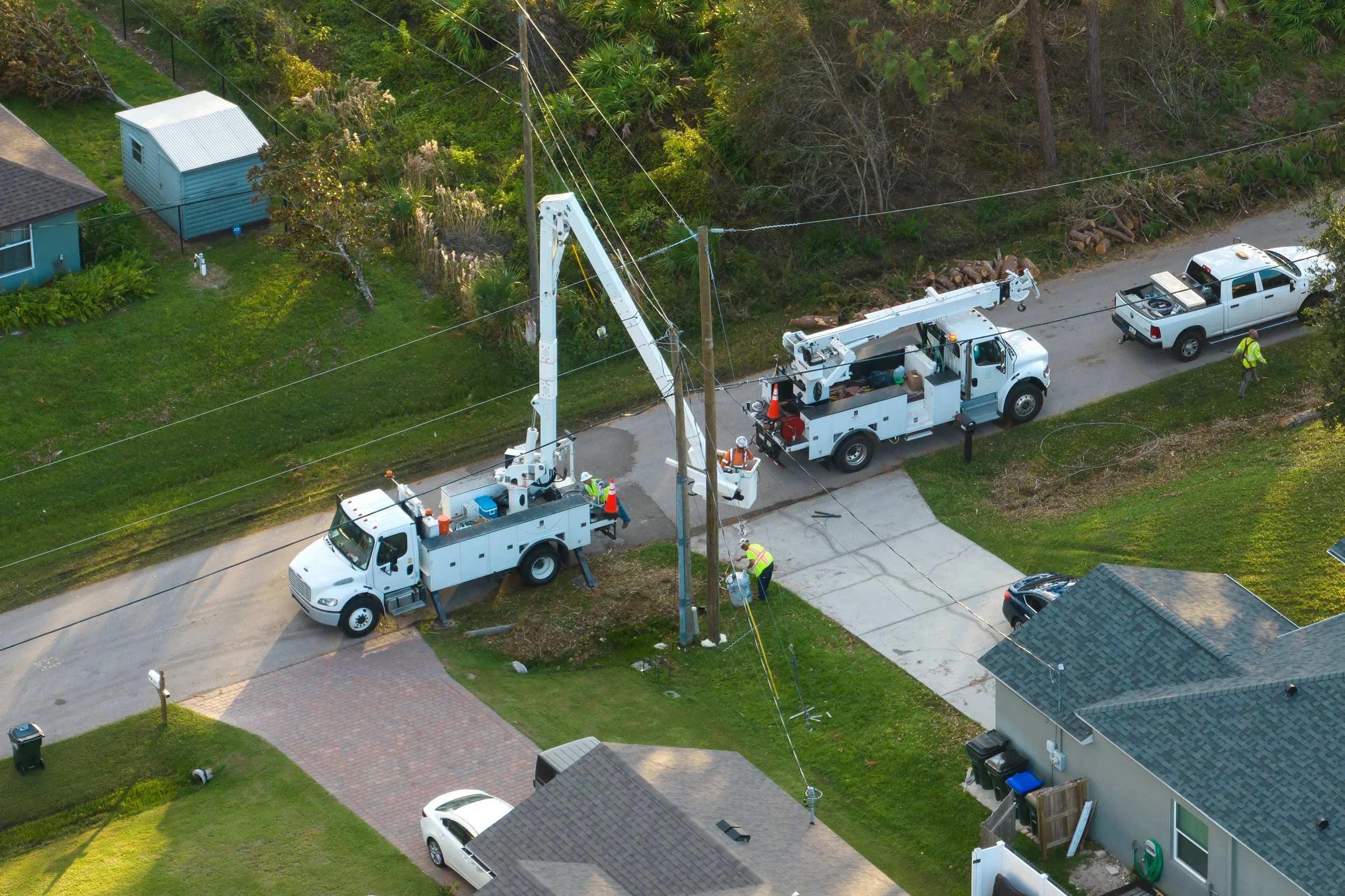 Traffic control setup with cones and bucket truck during roadside fiber optic repair operation
