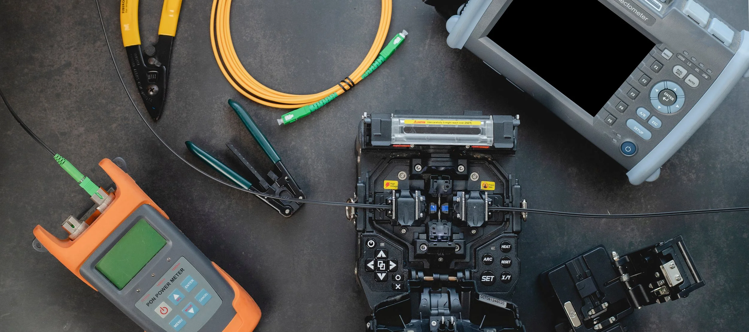 Close-up of fusion splicer aligning fiber optic cables for low-loss connection