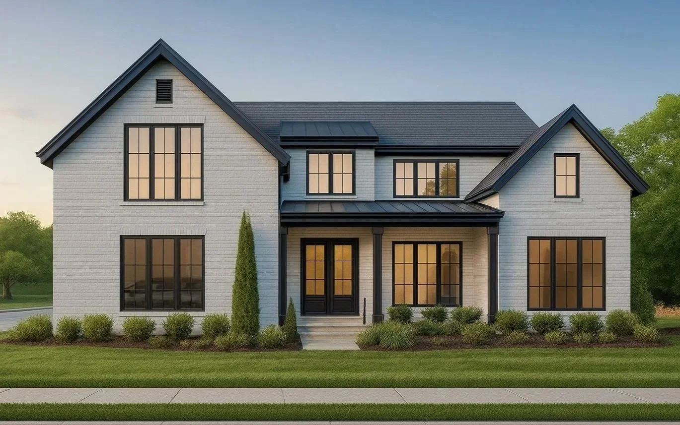 A two-story modern house with white brick exterior, black window frames, black front door, front porch with steps, landscaped front yard with grass, shrubs, and small trees, and a dark gray roof, set against a background of trees and a clear sky.