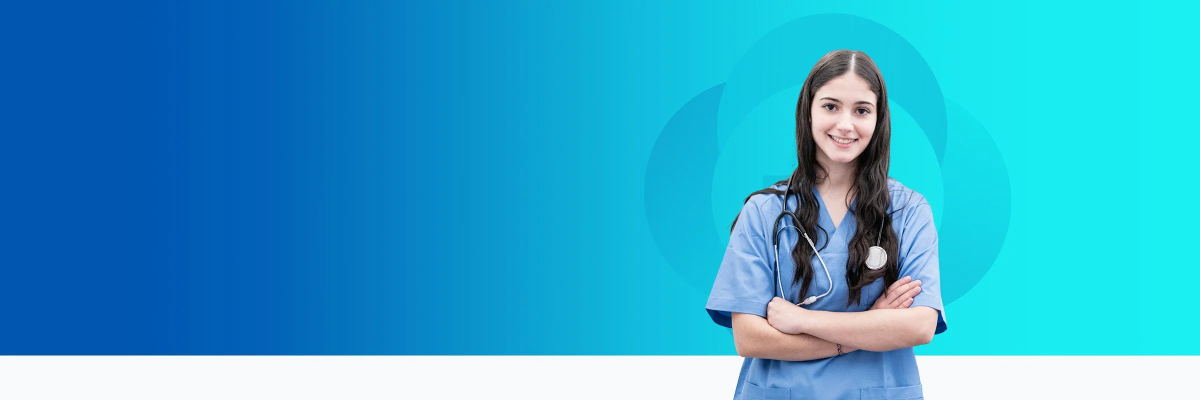 A young female healthcare professional in blue scrubs with a stethoscope around her neck, smiling and standing with arms crossed against a blue background.