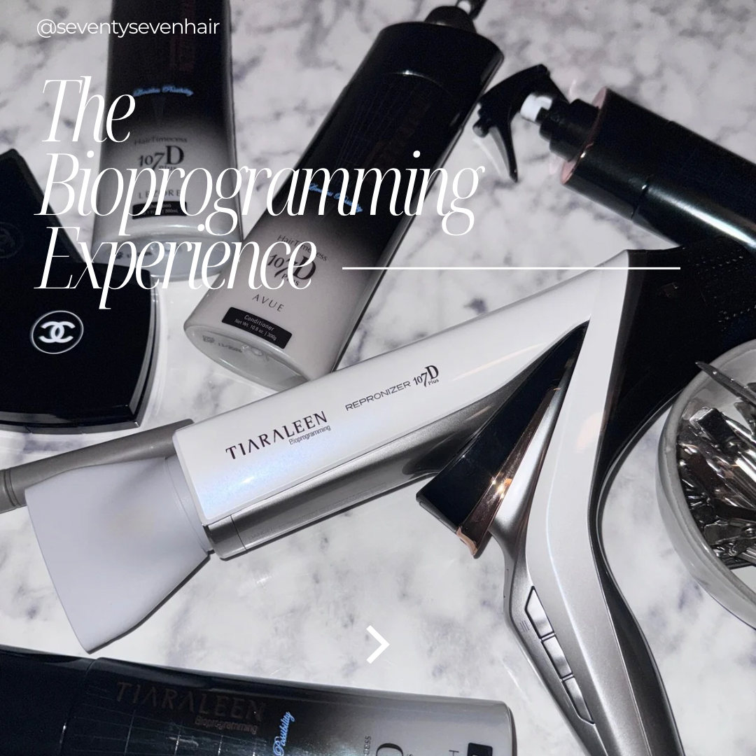 Various hair and beauty products including a Tiara Len Repronzor, a CHANEL compact, and other styling tools on a marble surface.