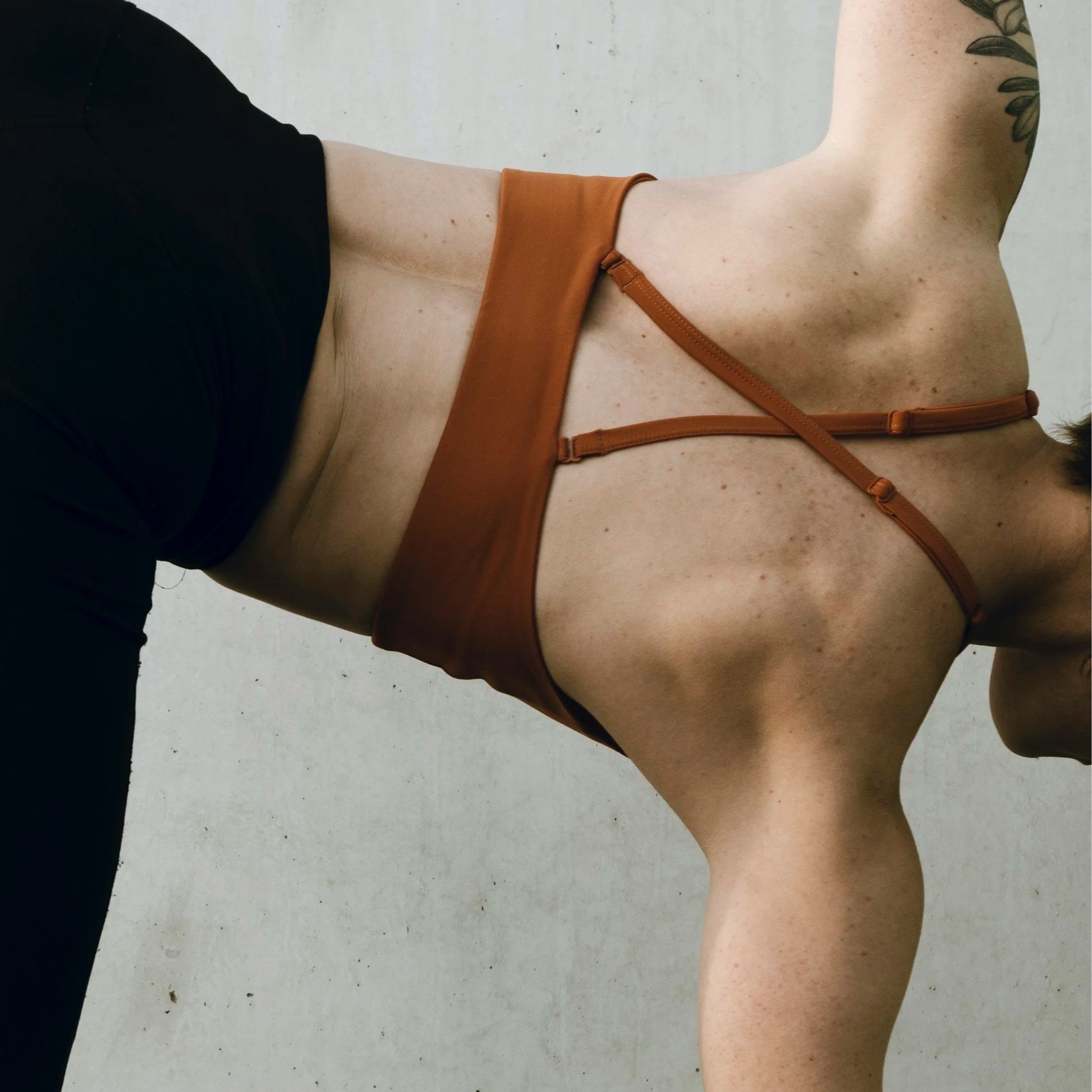 Modern Pilates studio interior in Jackson Heights NYC with blonde wood floors and natural light