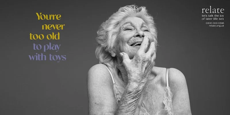 Older woman laughing to herself with the caption You're never to old to play with toys. from the Relate lets talk the joy of later life sex campaign