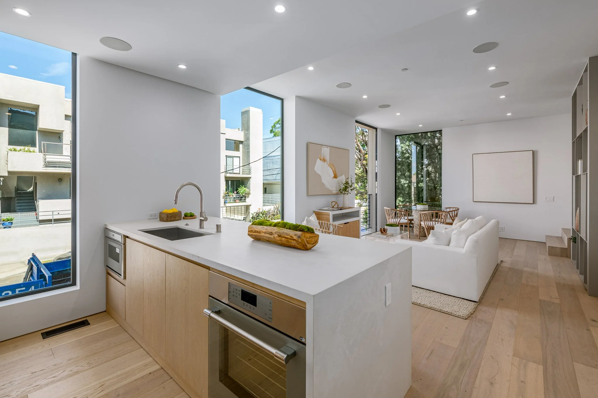 Entertaining kitchen centered around a generous quartz island, custom wood cabinetry, and an efficient open layout crafted by JBurton General Contractor.
