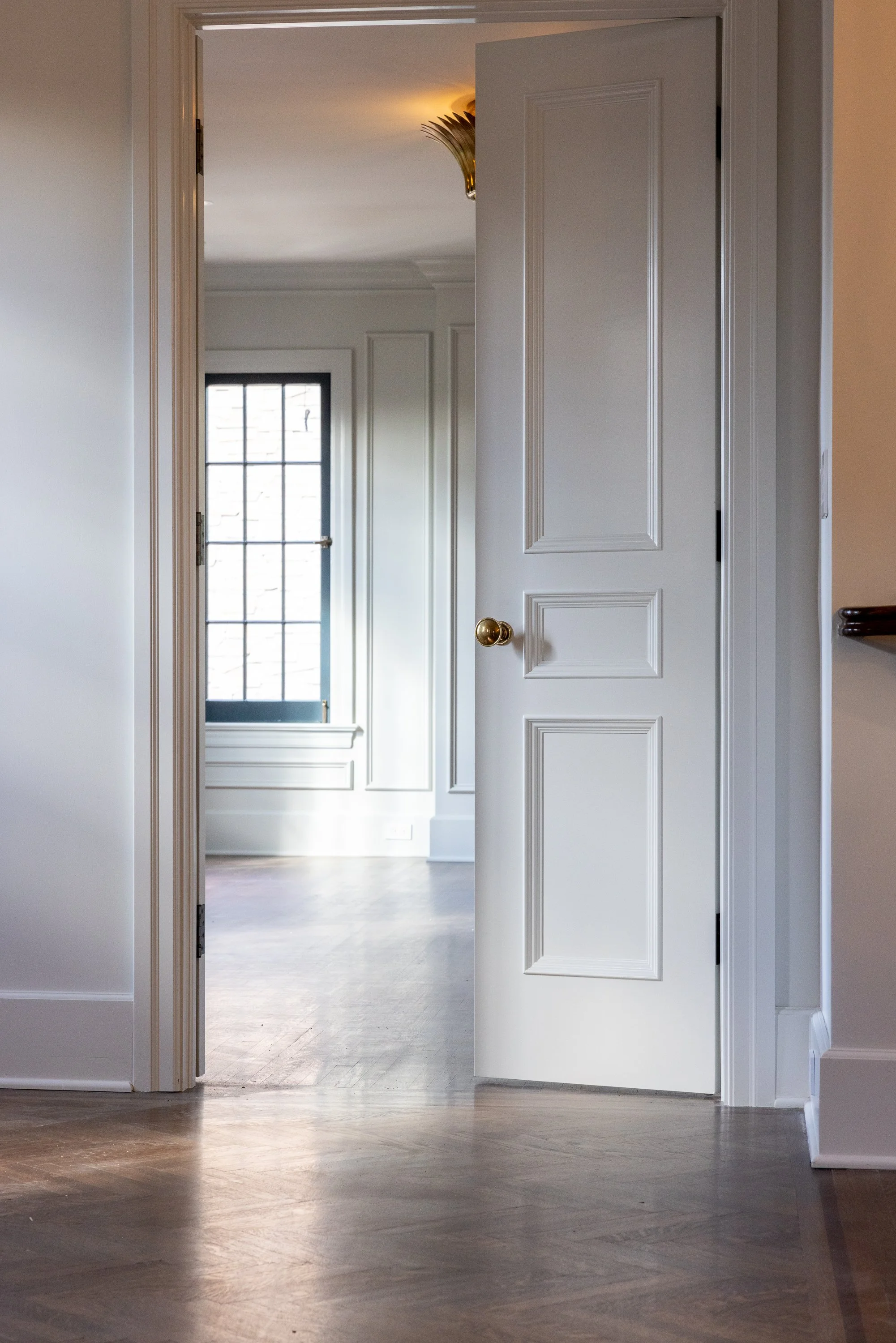Restored interior hallway with traditional millwork, paneled doors, and classic architectural details, thoughtfully renovated by JBurton General Contractor in Hancock Park.