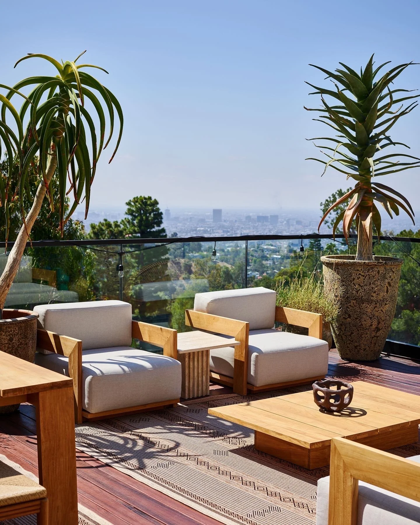 Outdoor terrace with lounge seating and panoramic city views, remodeled by JBurton General Contractor in Hollywood Hills, Los Angeles.