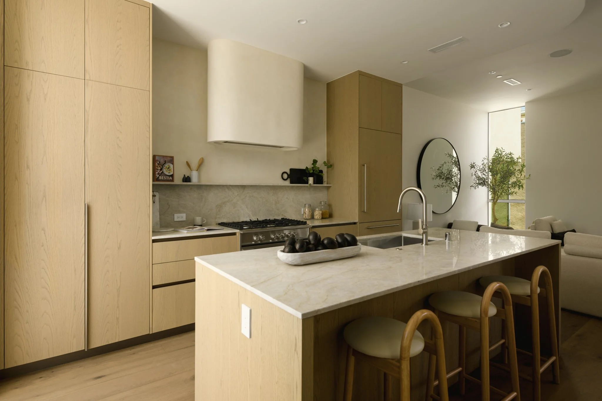 Modern kitchen featuring a waterfall island, custom wood cabinetry, and quartz countertops, built by JBurton General Contractor for luxury townhomes in Silver Lake, Los Angeles.