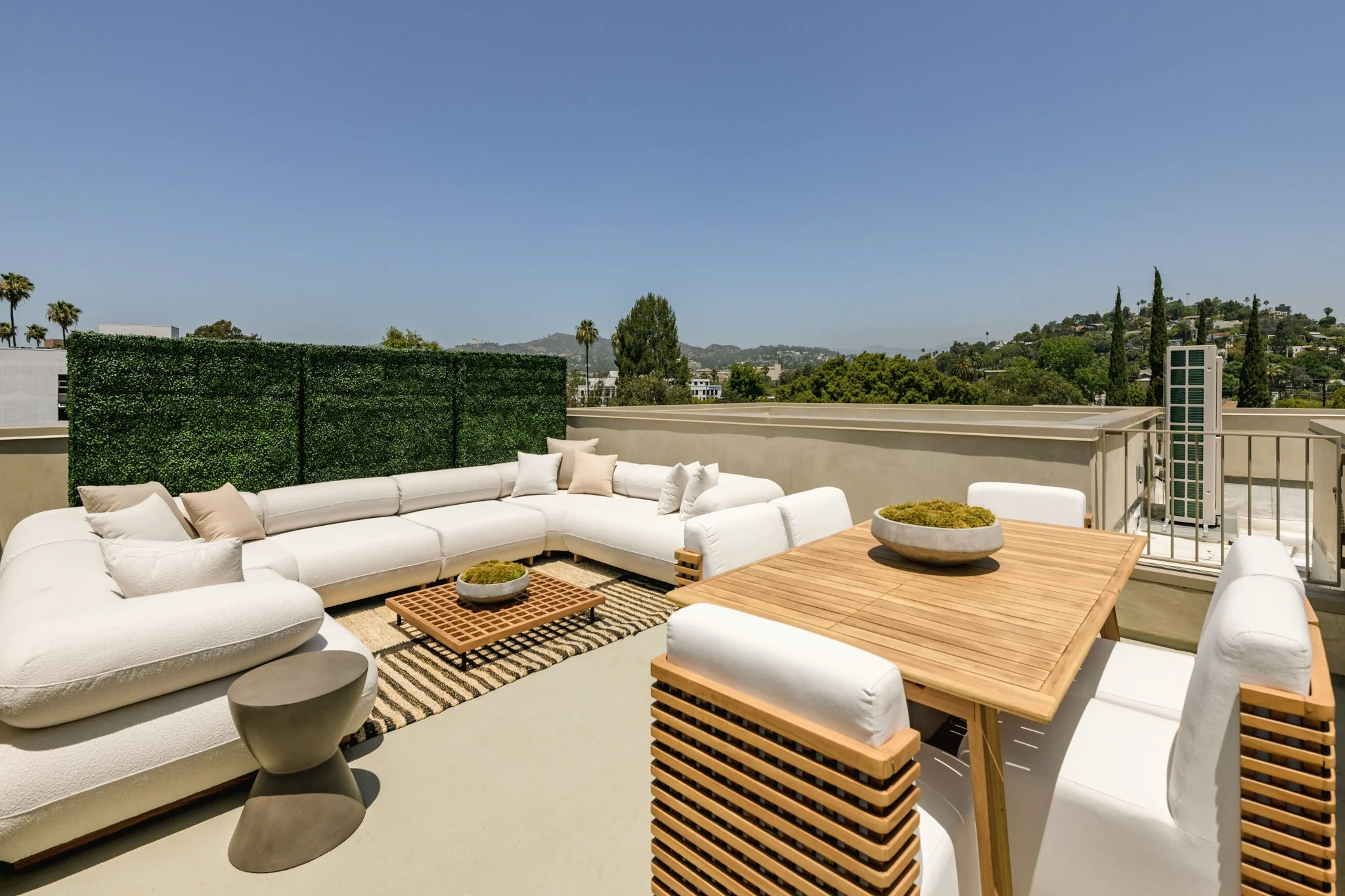 Private rooftop outdoor living area with lounge seating, dining space, and city views, completed by JBurton General Contractor for luxury townhomes in Silver Lake, Los Angeles.