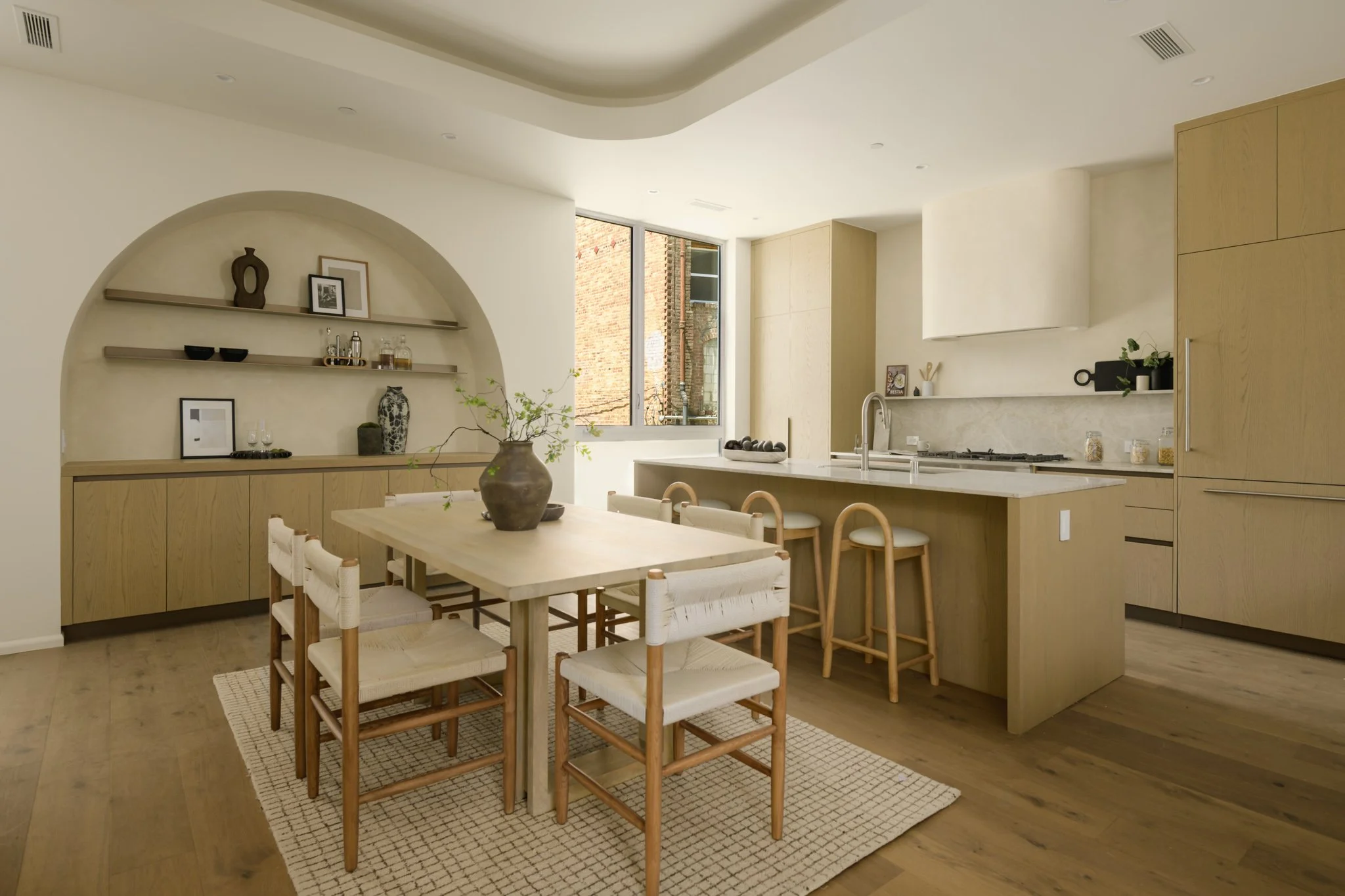 Open living room flowing into a modern kitchen with custom cabinetry and contemporary finishes, completed by JBurton General Contractor for new construction townhomes in Silver Lake, Los Angeles.