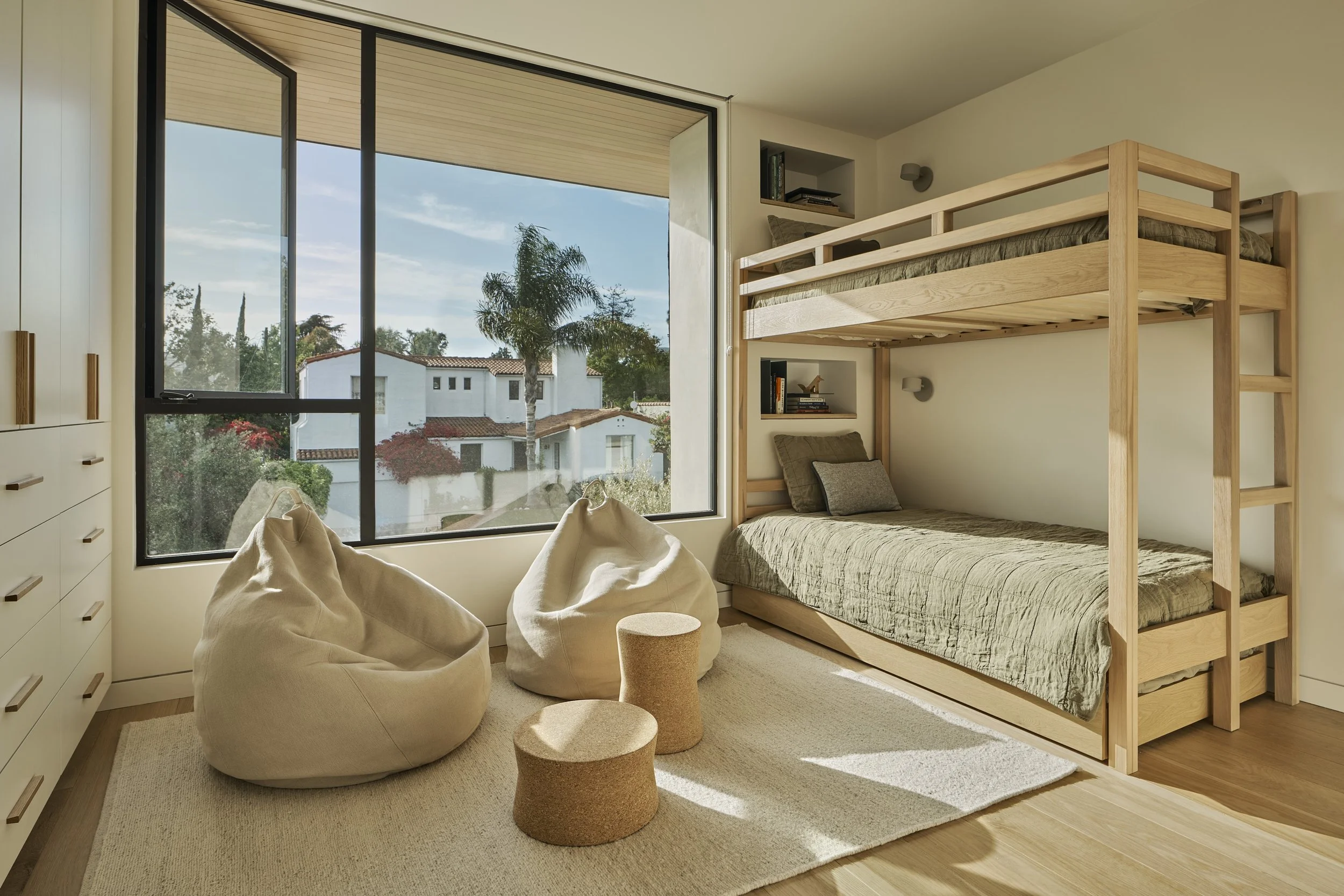 Kids' custom bunk room with built-in beds, floor-to-ceiling windows, and contemporary millwork, remodeled by JBurton General Contractor in Westwood, Los Angeles.