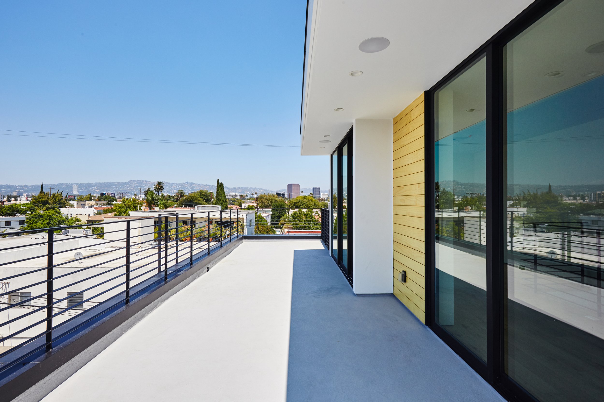 Modern rooftop terrace with expansive city views, contemporary exterior finishes, and outdoor living space built by JBurton General Contractor in Faircrest Heights, Los Angeles.