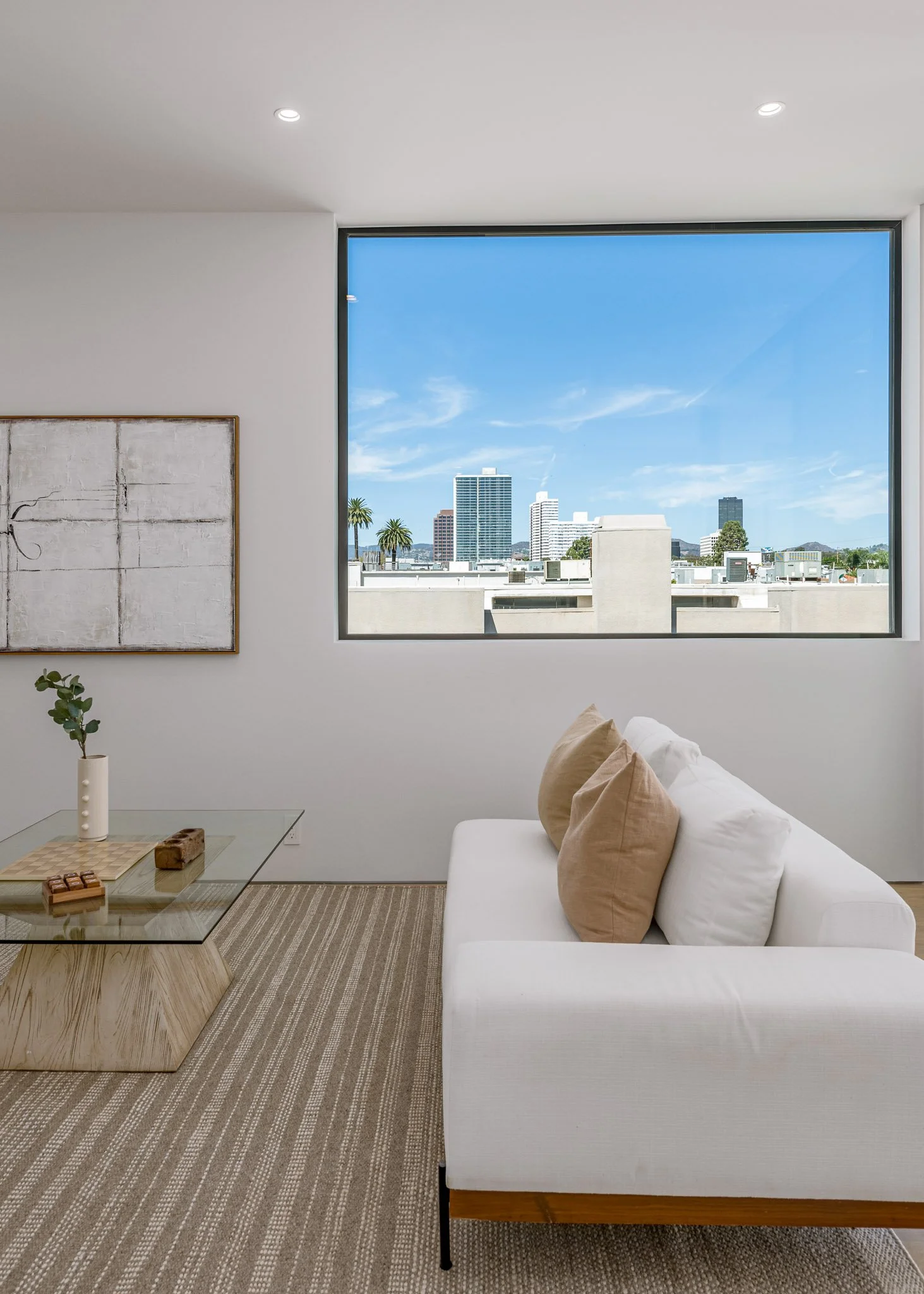 Light-filled sitting area framed by expansive windows overlooking the West Los Angeles skyline, thoughtfully constructed by JBurton General Contractor.