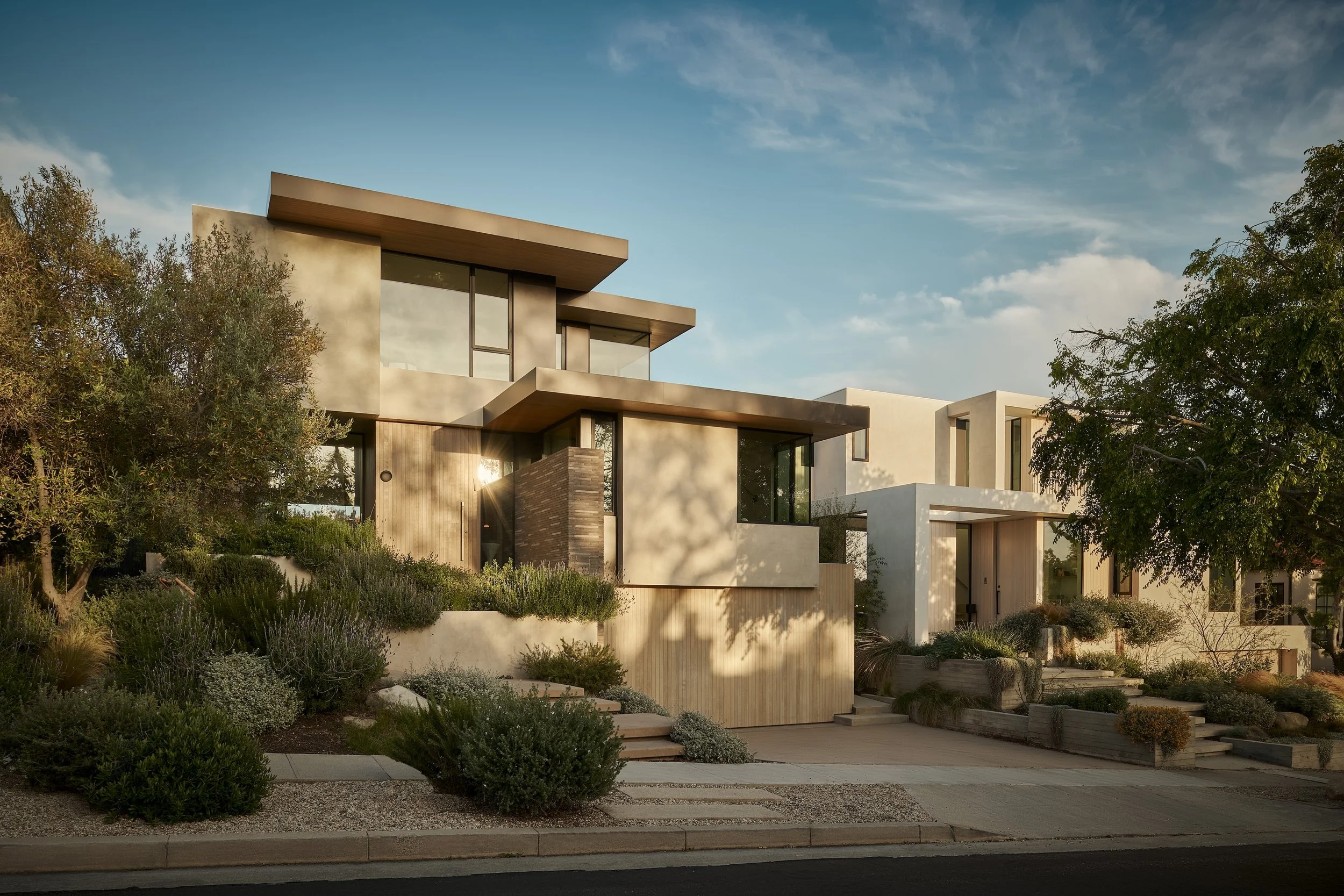 Modern front elevation showcasing custom architectural detailing, wood cladding, and drought-tolerant landscaping, remodeled by JBurton General Contractor in Westwood, Los Angeles.