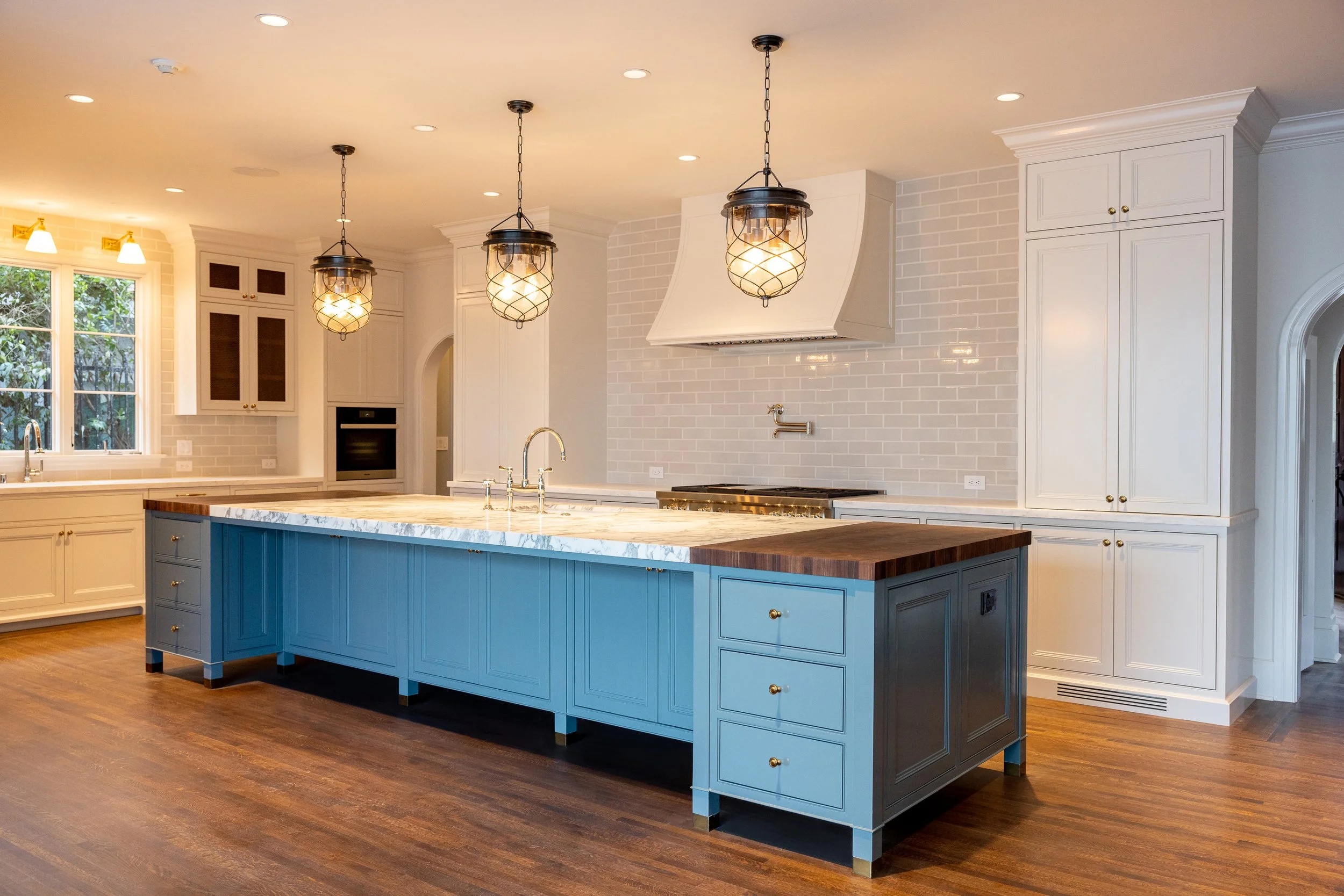 Custom kitchen with a blue island, marble countertops, and traditional cabinetry, remodeled by JBurton General Contractor in Hancock Park, Los Angeles.