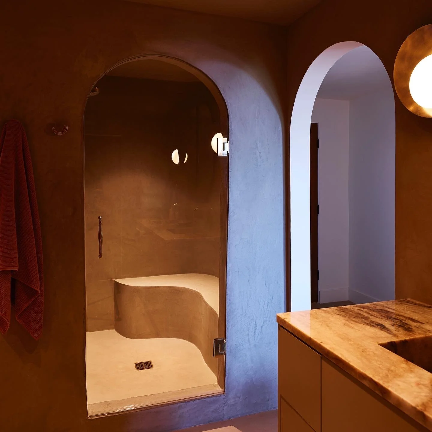 Walk-in shower with arched entry, custom plaster walls, and contemporary finishes, remodeled by JBurton General Contractor in Hollywood Hills, Los Angeles.