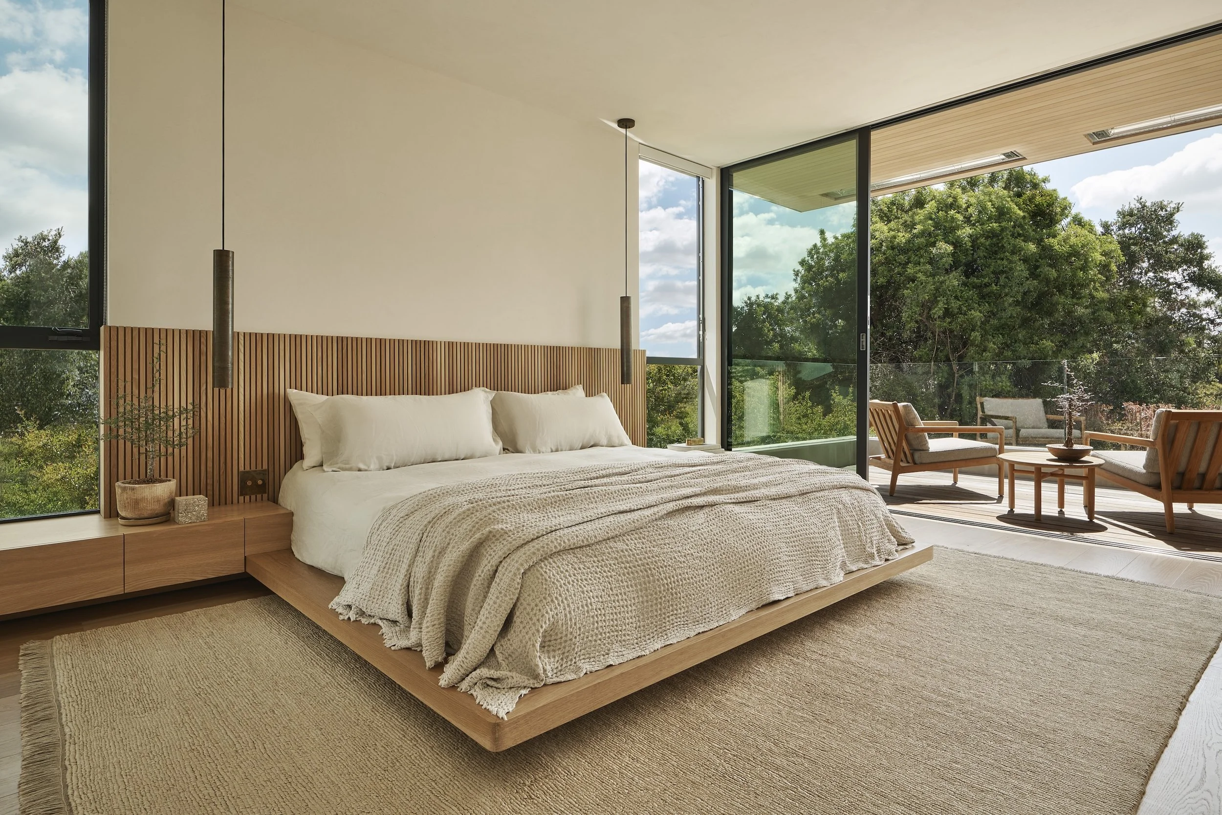 Primary bedroom with floor-to-ceiling glass, natural wood finishes, and seamless indoor-outdoor living, remodeled by JBurton General Contractor in Beverly Crest, Los Angeles.