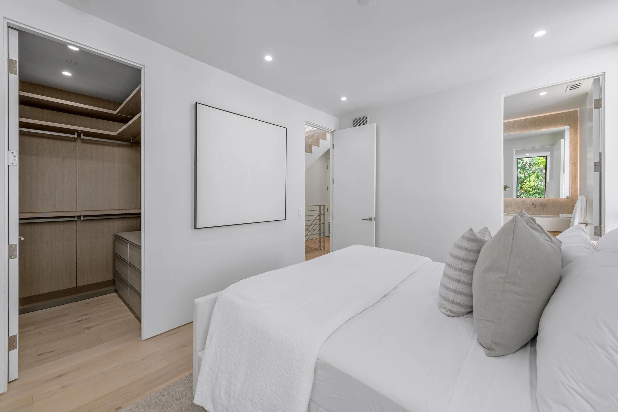 Flexible bedroom with custom storage, clean architectural detailing, and abundant natural light, completed by JBurton General Contractor.