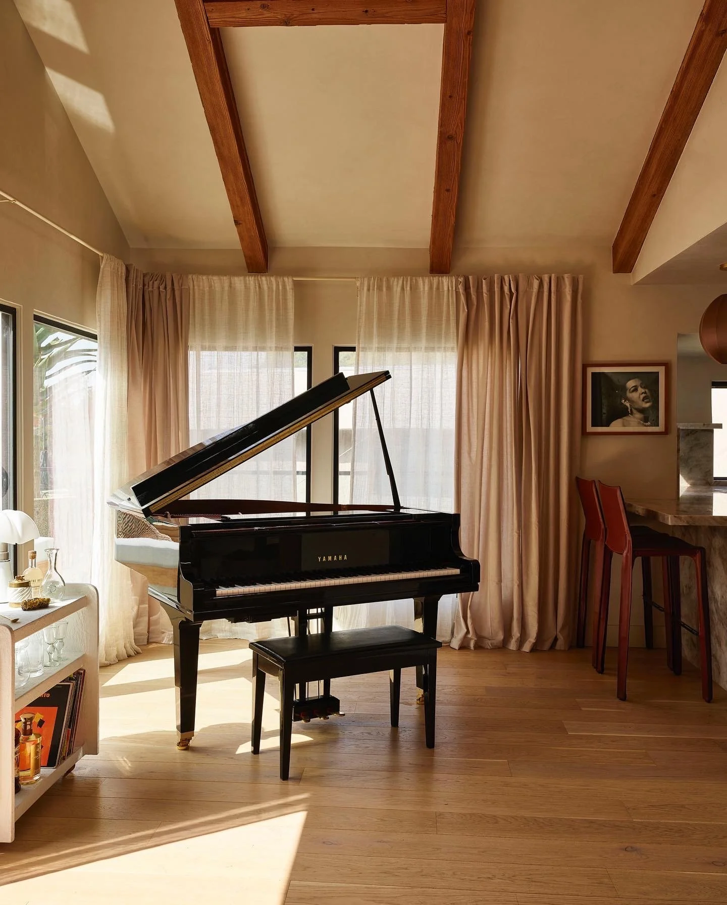 Music room featuring a grand piano, exposed wood beams, and custom millwork, remodeled by JBurton General Contractor in Hollywood Hills, Los Angeles.