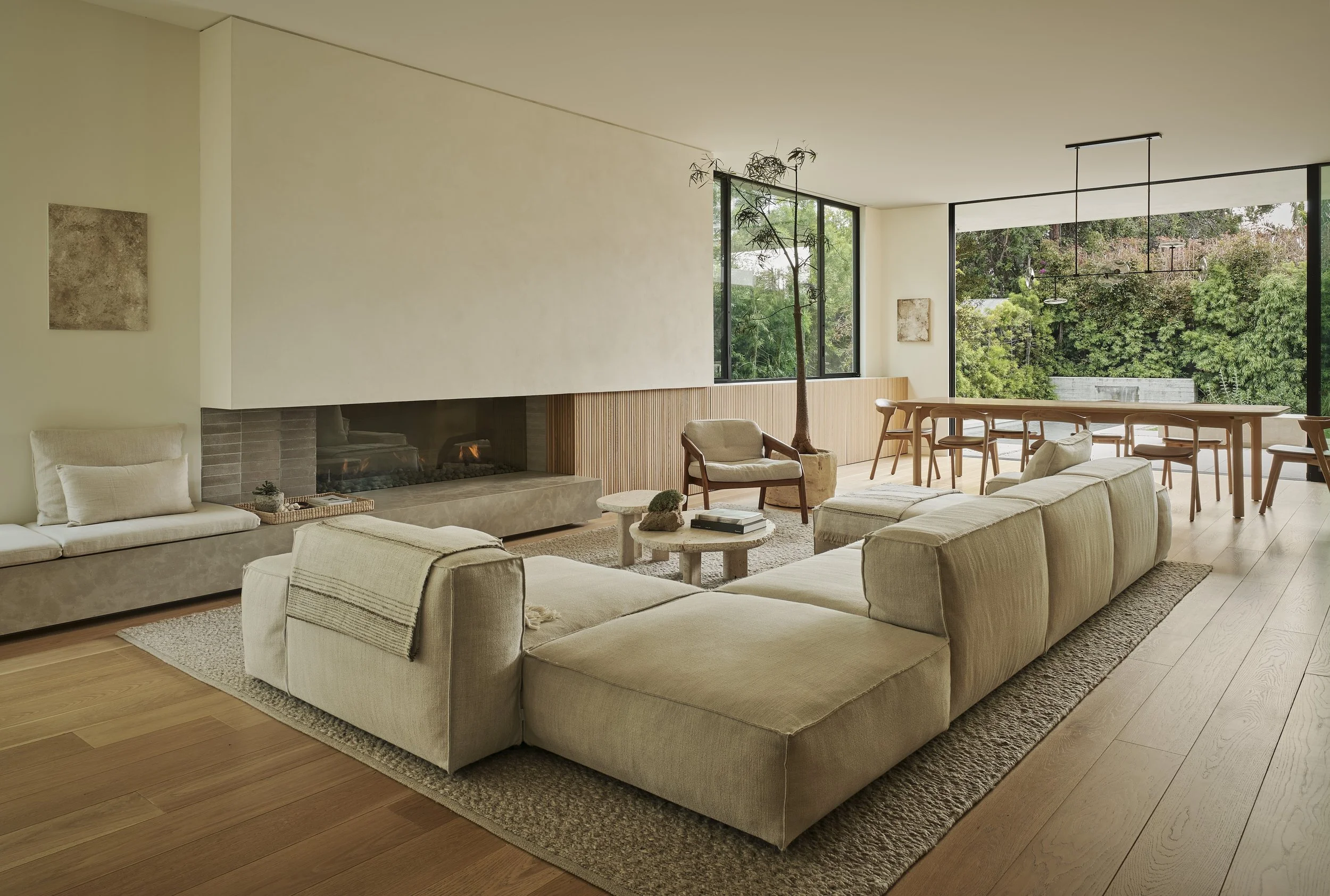 Great room with a linear fireplace, floor-to-ceiling windows, and contemporary furnishings, remodeled by JBurton General Contractor in Beverly Crest, Los Angeles.