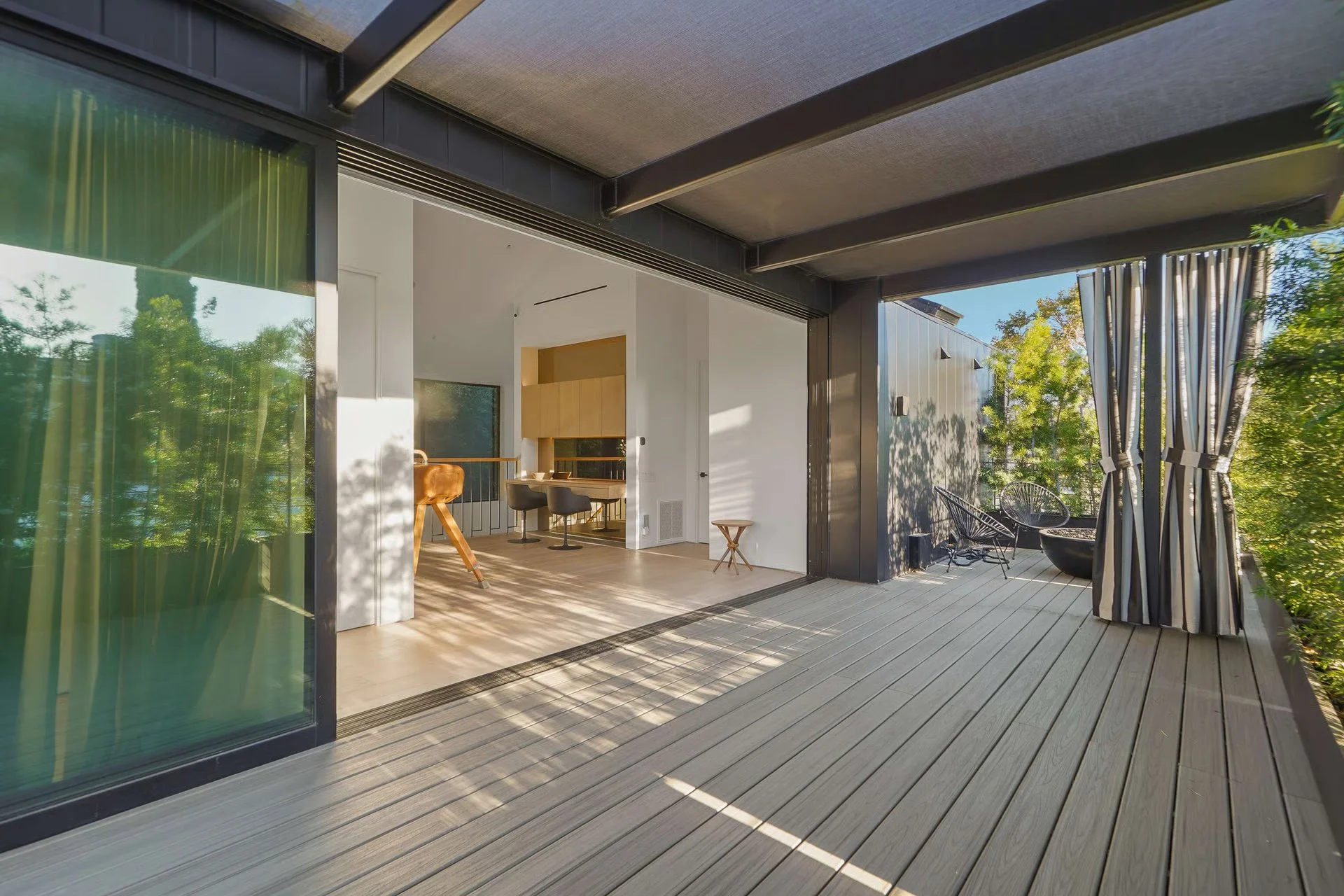 ndoor-outdoor entertaining space with expansive sliding glass doors opening to a covered deck, remodeled by JBurton General Contractor in Beverly Grove, Los Angeles.