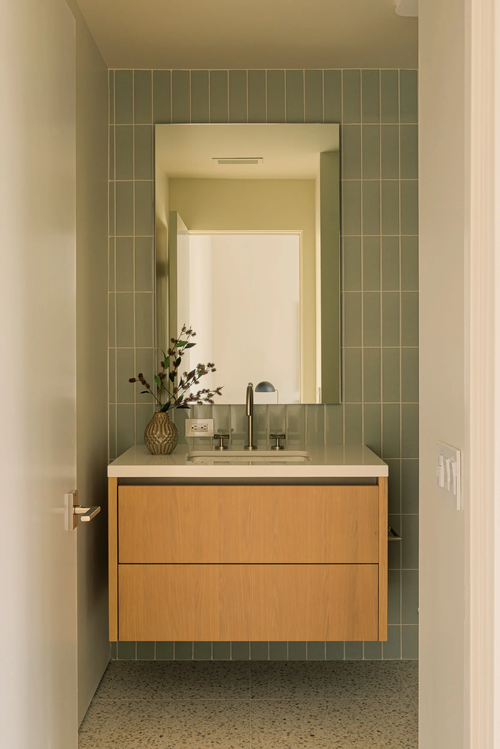 Custom bathroom vanity with wood cabinetry, full-height mirror, and contemporary finishes, remodeled by JBurton General Contractor in Beverly Crest, Los Angeles.