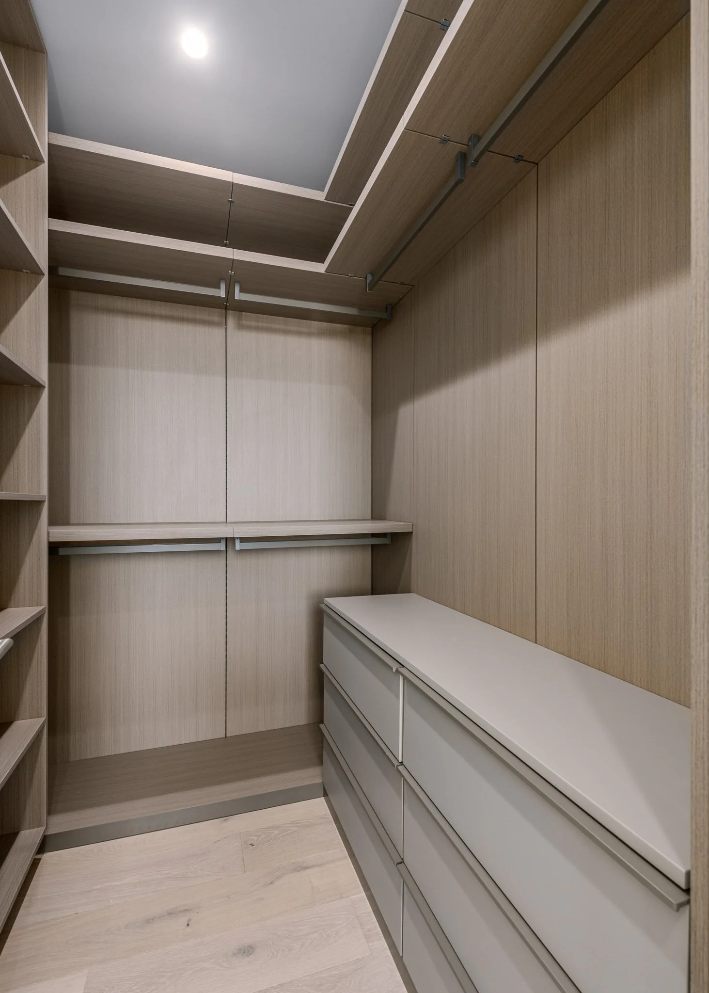 Custom dressing room with built-in wardrobes, integrated drawers, and tailored storage solutions designed for organized everyday living by JBurton General Contractor.