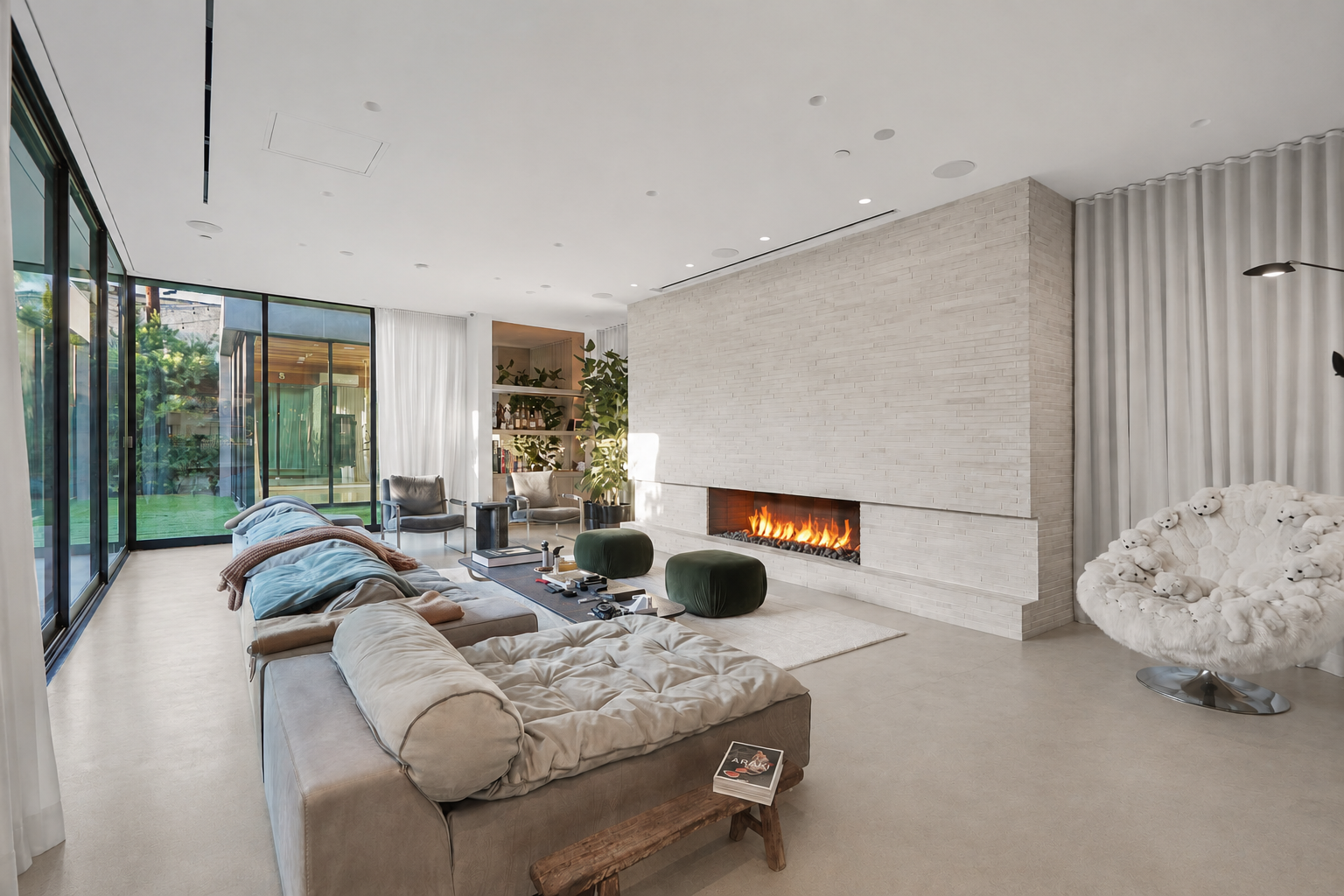 Contemporary living room featuring a linear fireplace with large-format stone surround and modern furnishings, remodeled by JBurton General Contractor in Beverly Grove, Los Angeles.