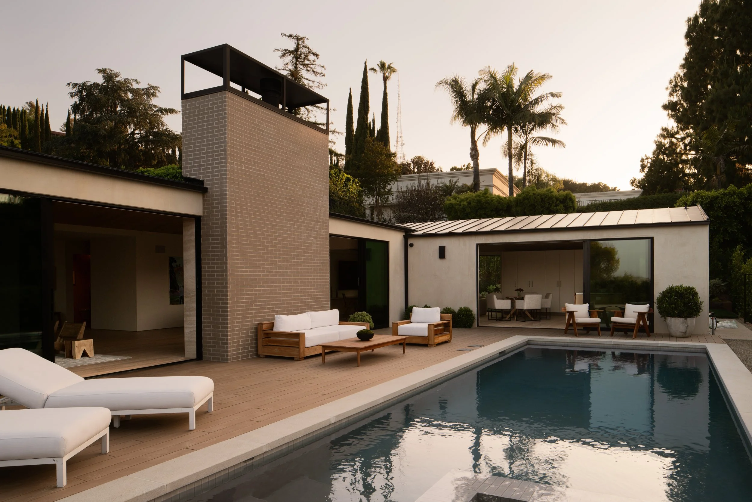 Contemporary backyard with a swimming pool, outdoor lounge, and seamless indoor-outdoor living, remodeled by JBurton General Contractor in Beverly Crest, Los Angeles.