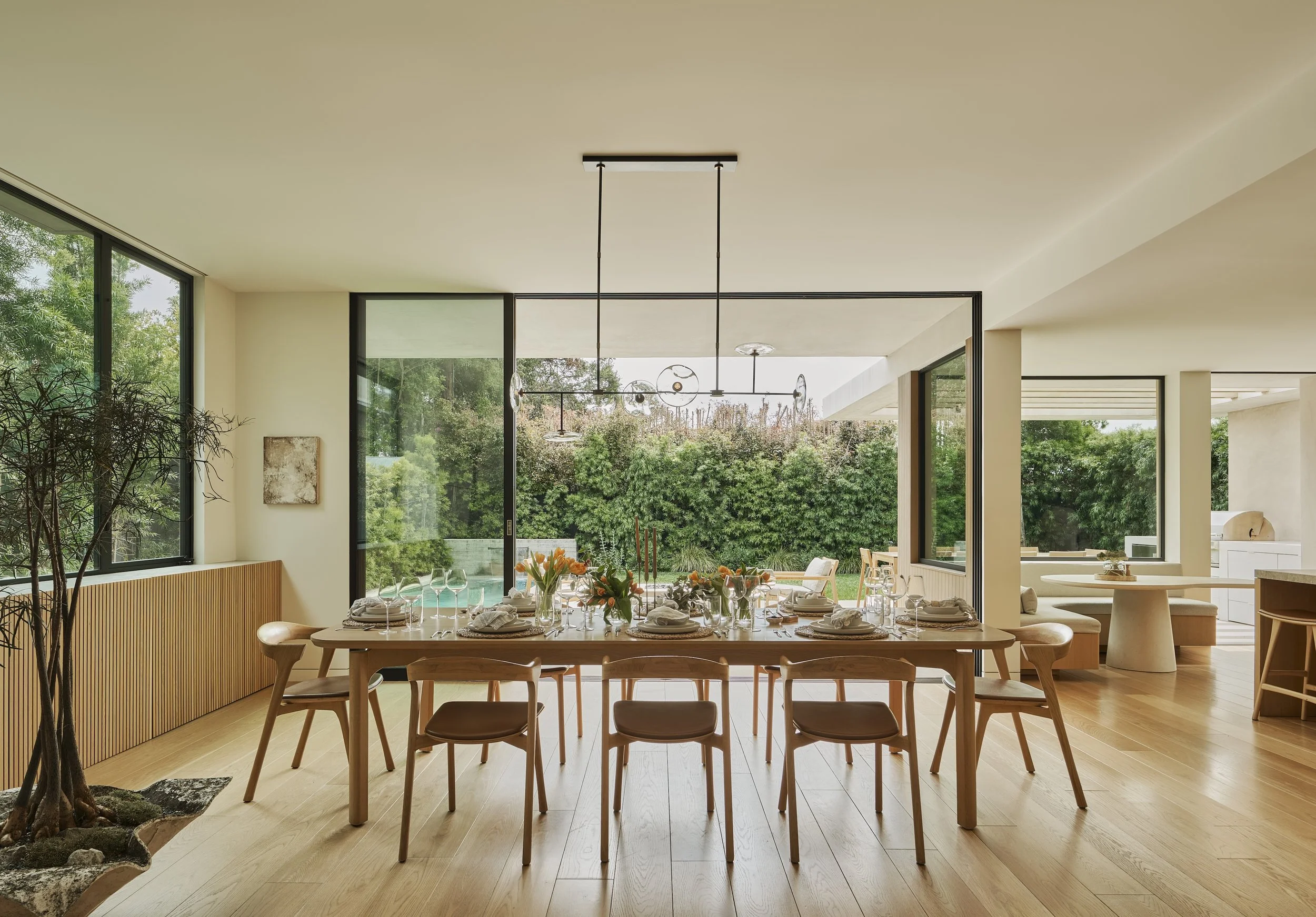 Contemporary dining room with floor-to-ceiling glass and seamless indoor-outdoor living, remodeled by JBurton General Contractor in Beverly Crest, Los Angeles.