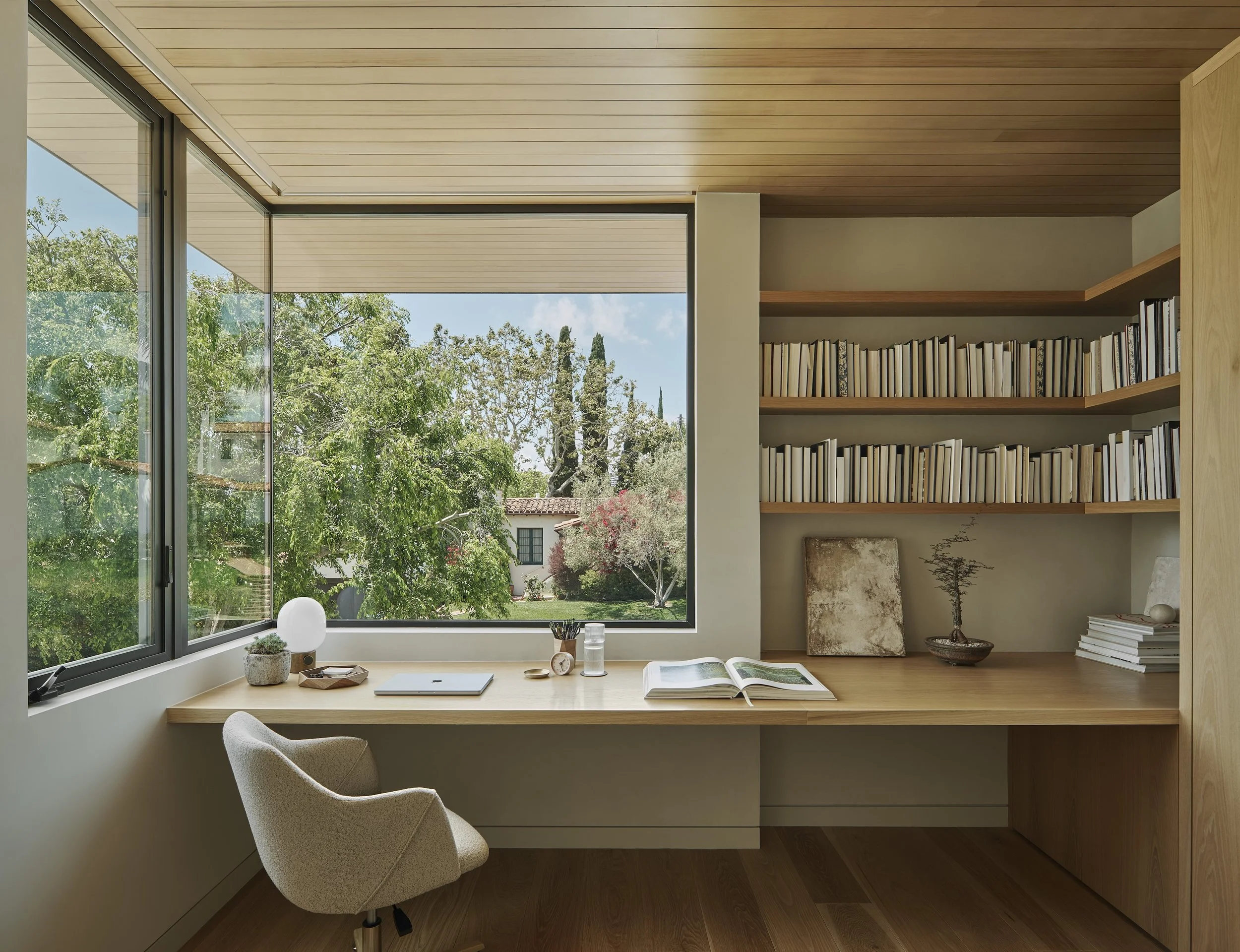 Custom home office with built-in desk, shelving, and panoramic windows, remodeled by JBurton General Contractor in Beverly Crest, Los Angeles.