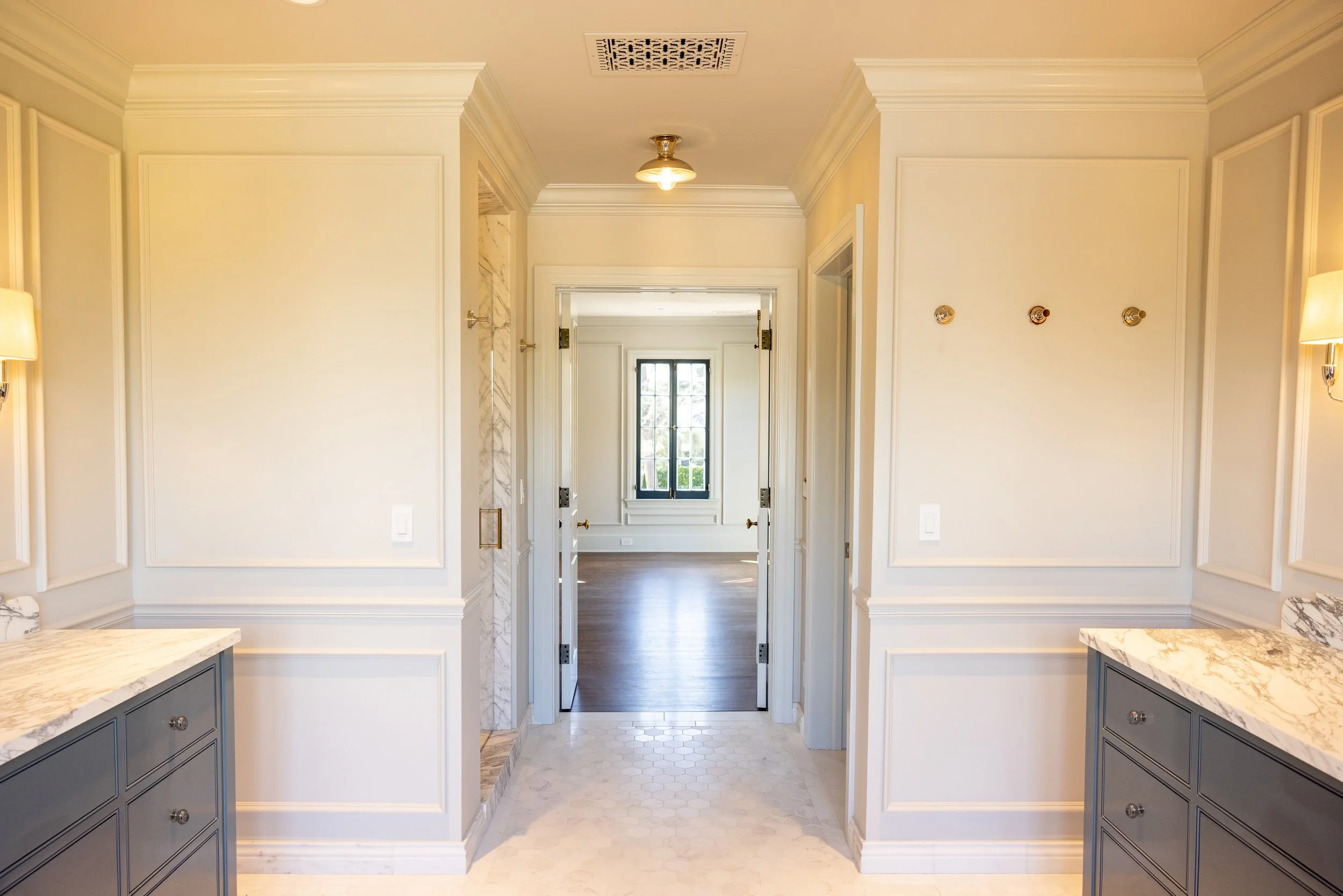 Restored hallway with traditional millwork, hardwood flooring, and classic architectural detailing, remodeled by JBurton General Contractor in Hancock Park, Los Angeles.