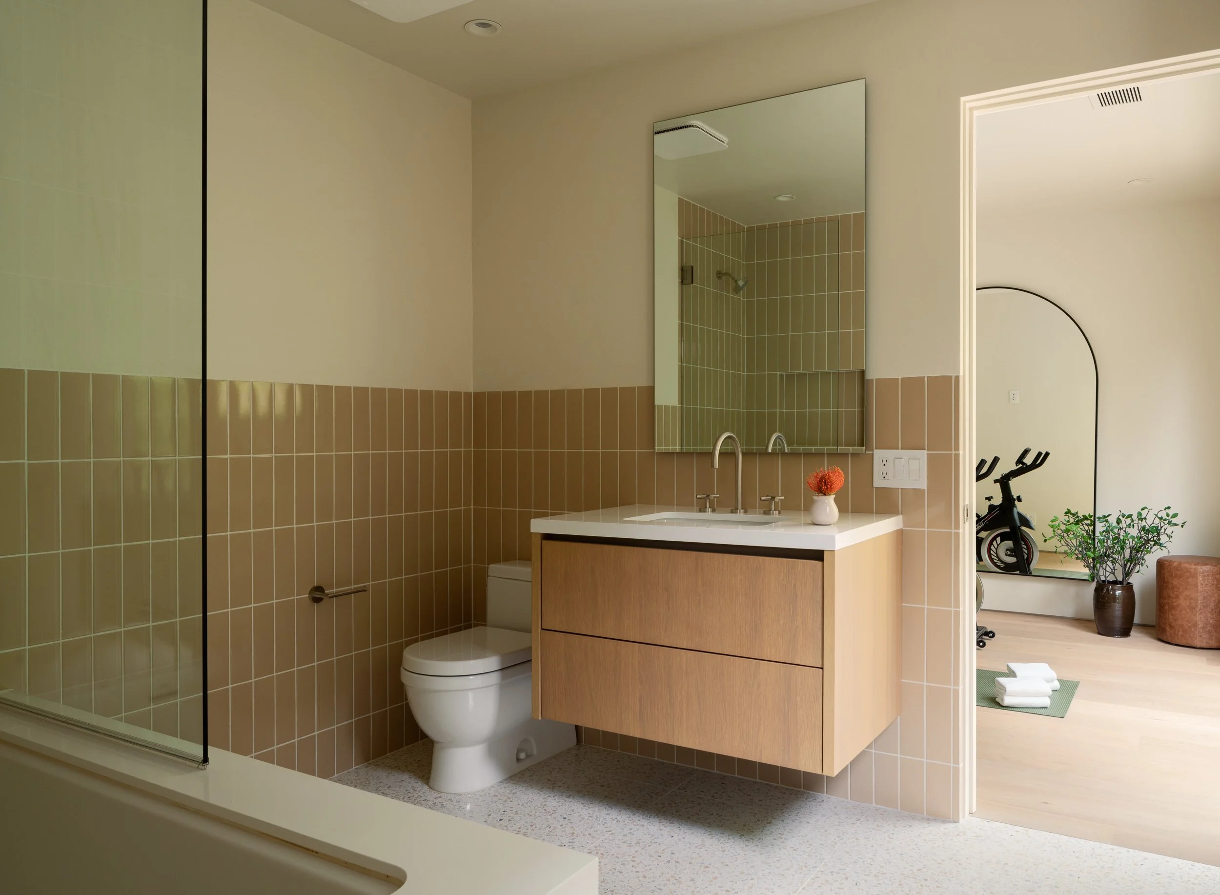 Guest bathroom with floating wood vanity, modern tilework, and contemporary fixtures, remodeled by JBurton General Contractor in Beverly Crest, Los Angeles.