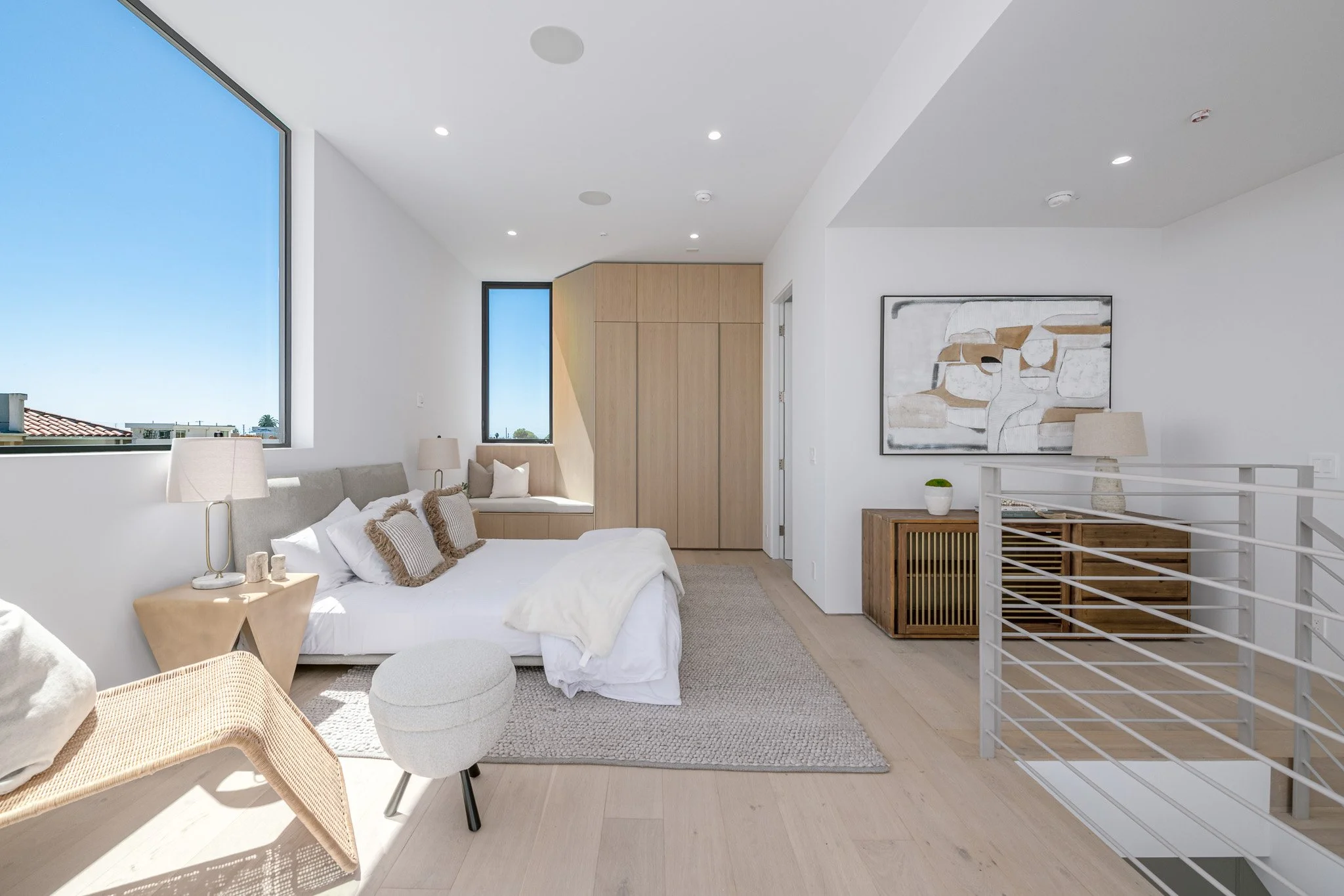 Flexible bedroom suite with a comfortable sitting area, abundant natural light, and custom storage, constructed by JBurton General Contractor.