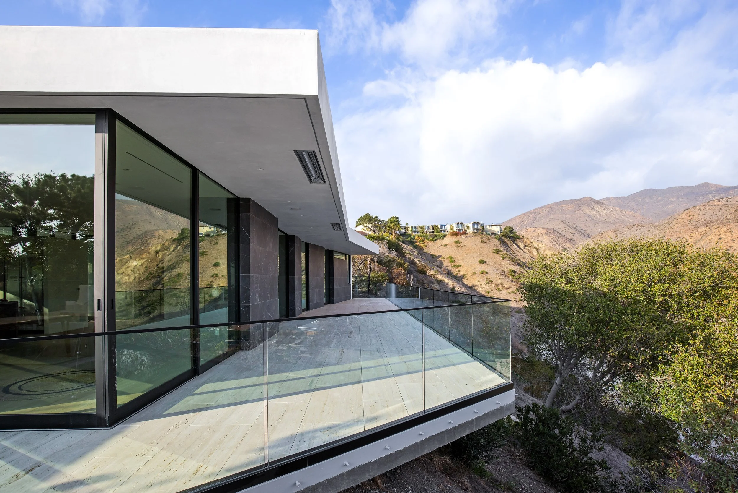 Glass balcony overlooking the Malibu hills at a custom luxury residence built by JBurton General Contractor.