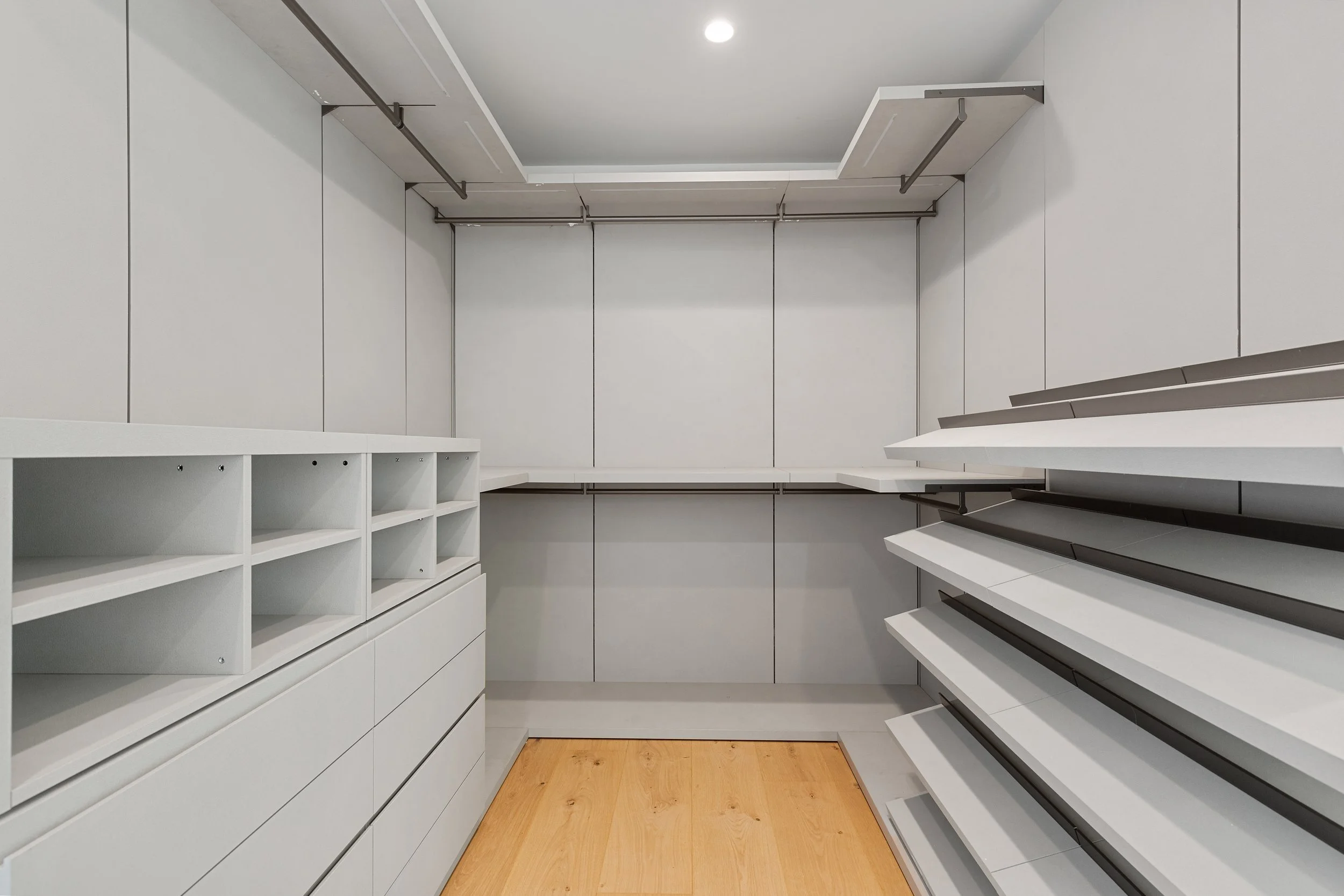 Custom walk-in closet with built-in shelving, integrated storage solutions, and precision millwork designed for organized everyday living by JBurton General Contractor.
