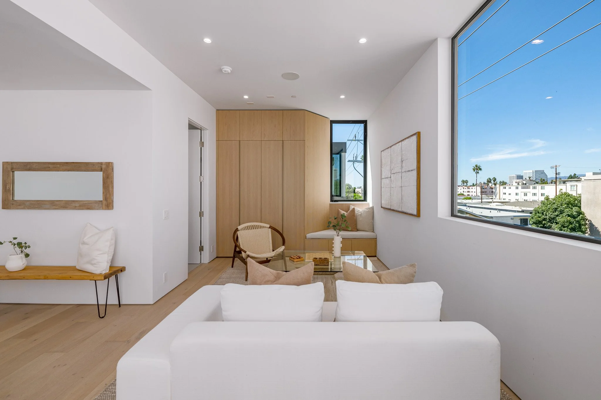 Primary bedroom suite with a private sitting area, custom millwork, and abundant natural light, built by JBurton General Contractor.