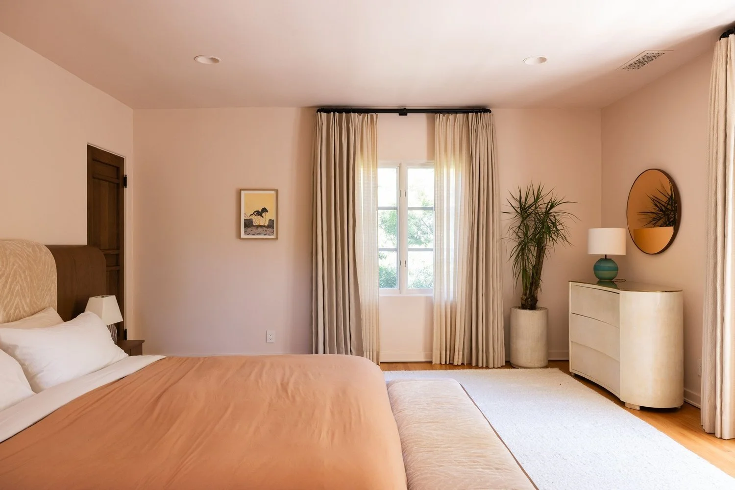 Tranquil primary bedroom renovation with natural light, custom finishes, and timeless Spanish Revival design elements.