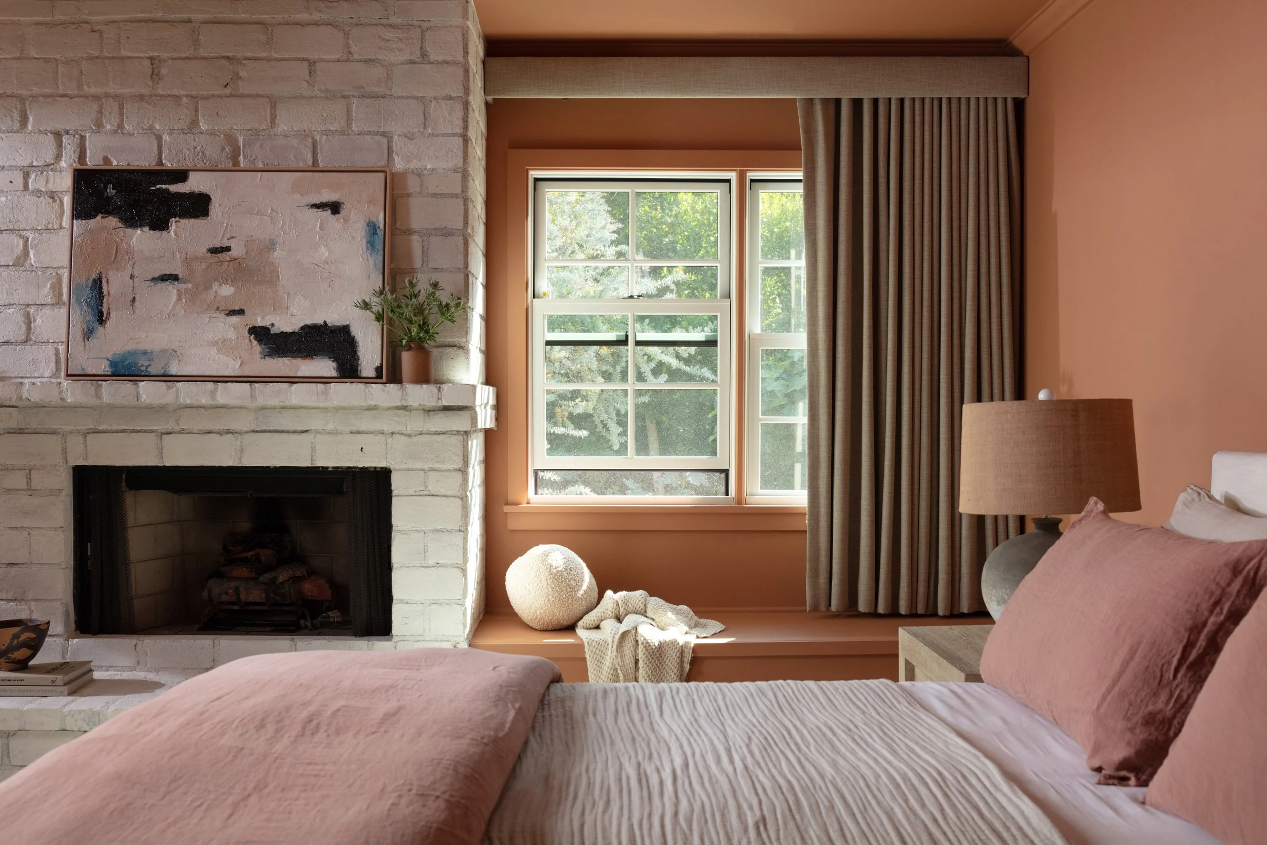 Primary bedroom featuring custom windows, warm contemporary finishes, and a painted brick fireplace, completed by JBurton General Contractor in Brentwood, Los Angeles.
