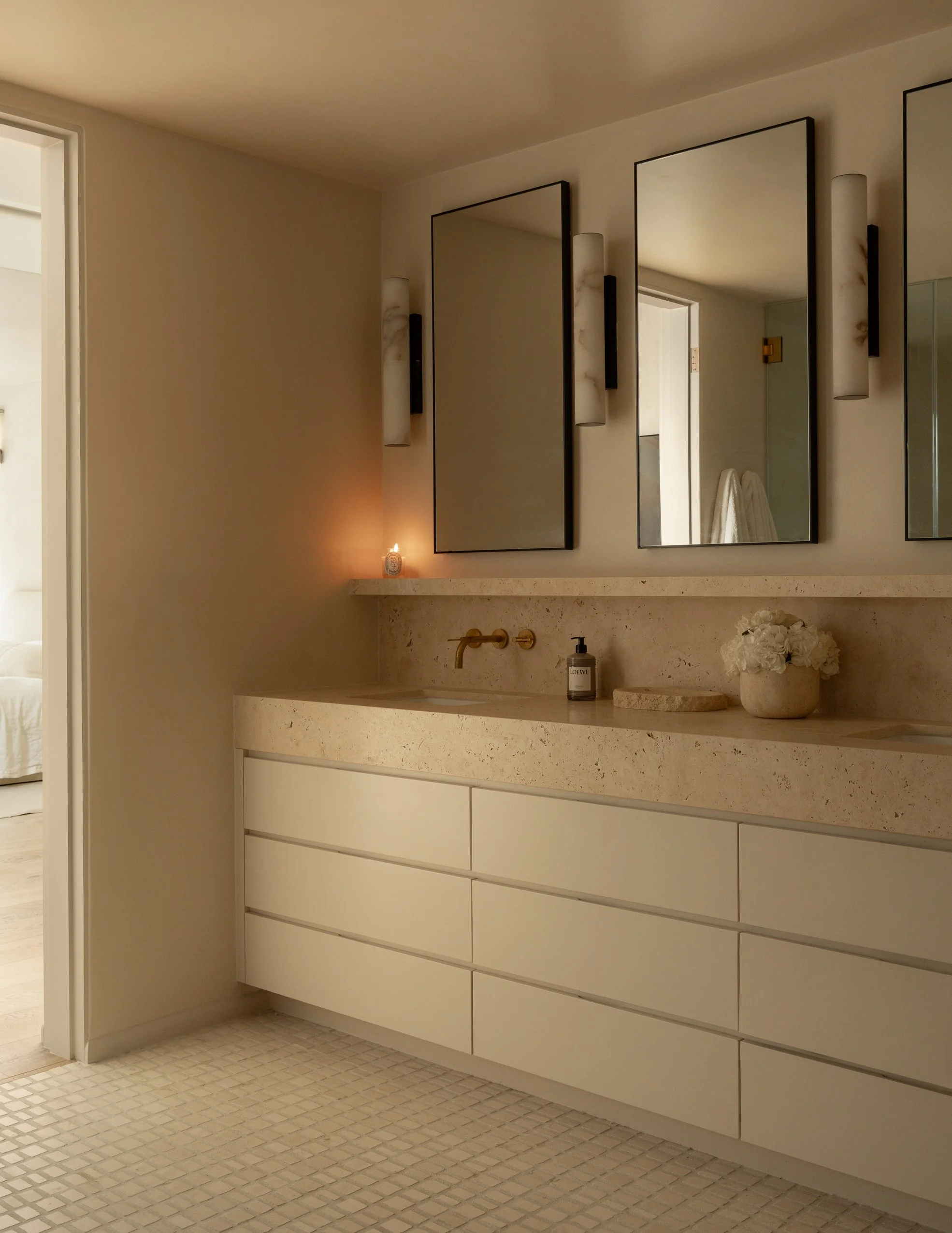 Custom floating bathroom vanity with integrated stone countertop and modern fixtures, remodel completed by JBurton General Contractor for a luxury home renovation in Benedict Canyon, Los Angeles.