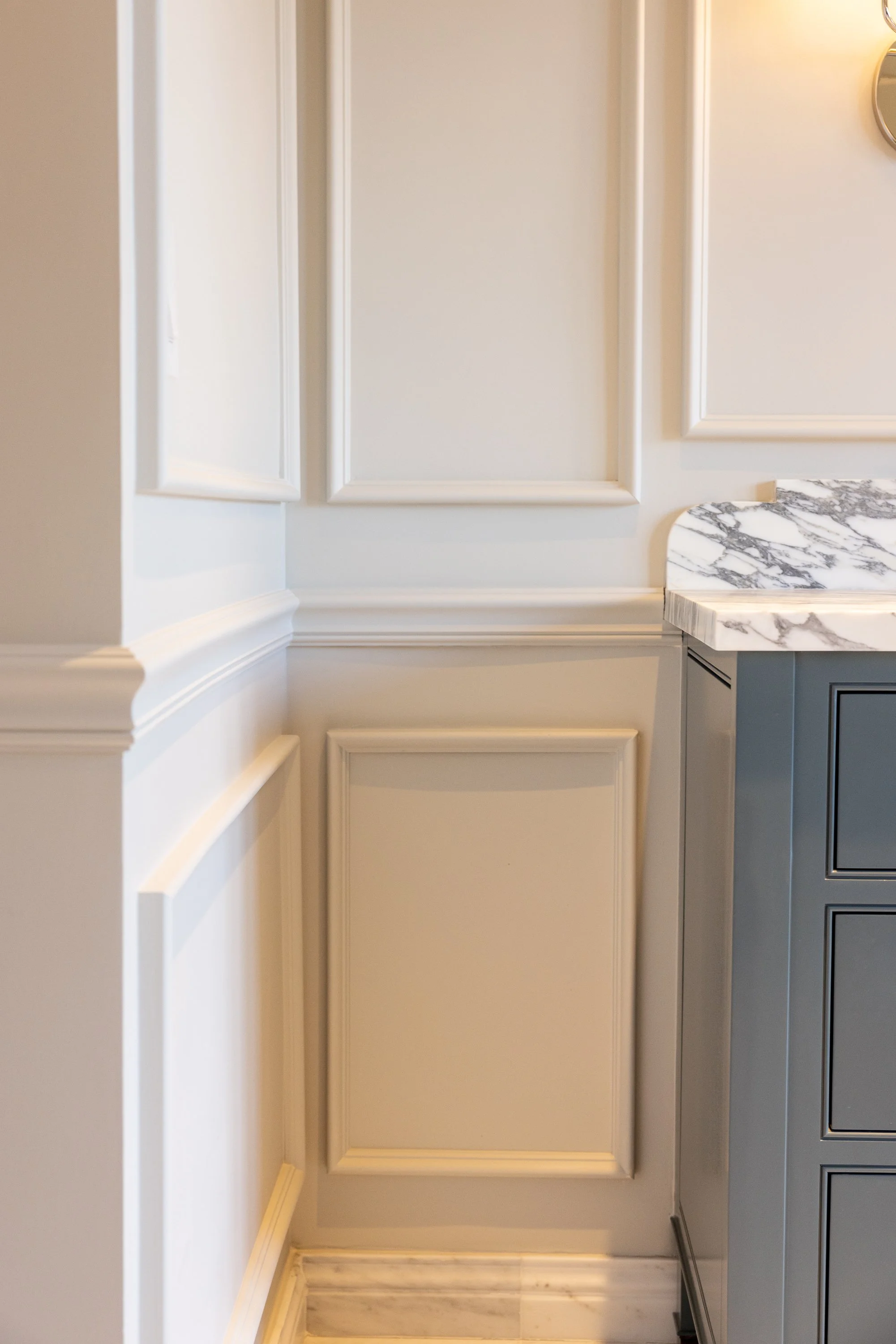 Elegant bathroom with custom wall panel molding, marble vanity, and traditional millwork, showcasing the craftsmanship of JBurton General Contractor during a Hancock Park home remodel.