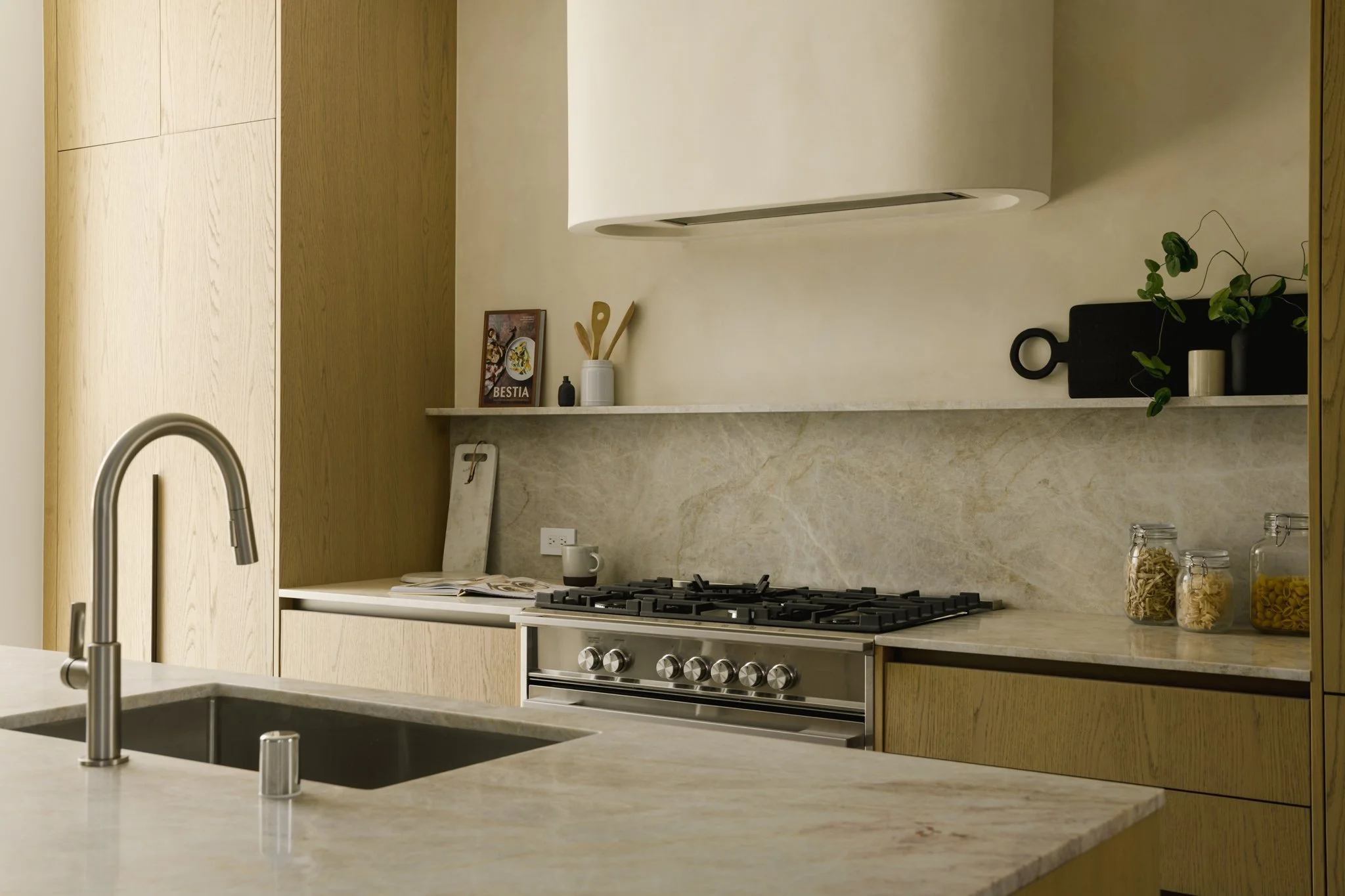 Contemporary custom kitchen with a marble backsplash, integrated range hood, and premium appliances, completed by JBurton General Contractor for new construction townhomes in Silver Lake, Los Angeles.