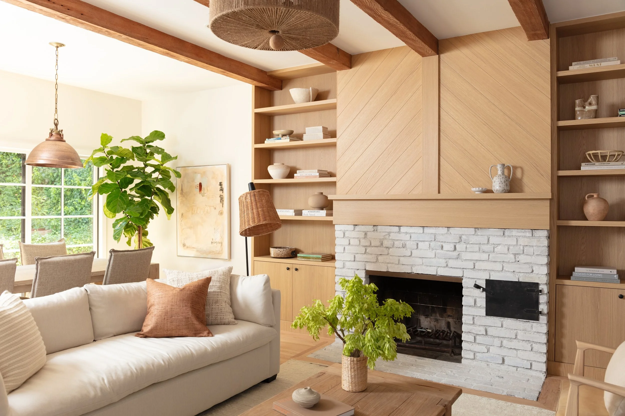 Custom white oak built-ins and architectural millwork surrounding a painted brick fireplace, crafted by JBurton General Contractor during a whole-home remodel in Brentwood, Los Angeles.