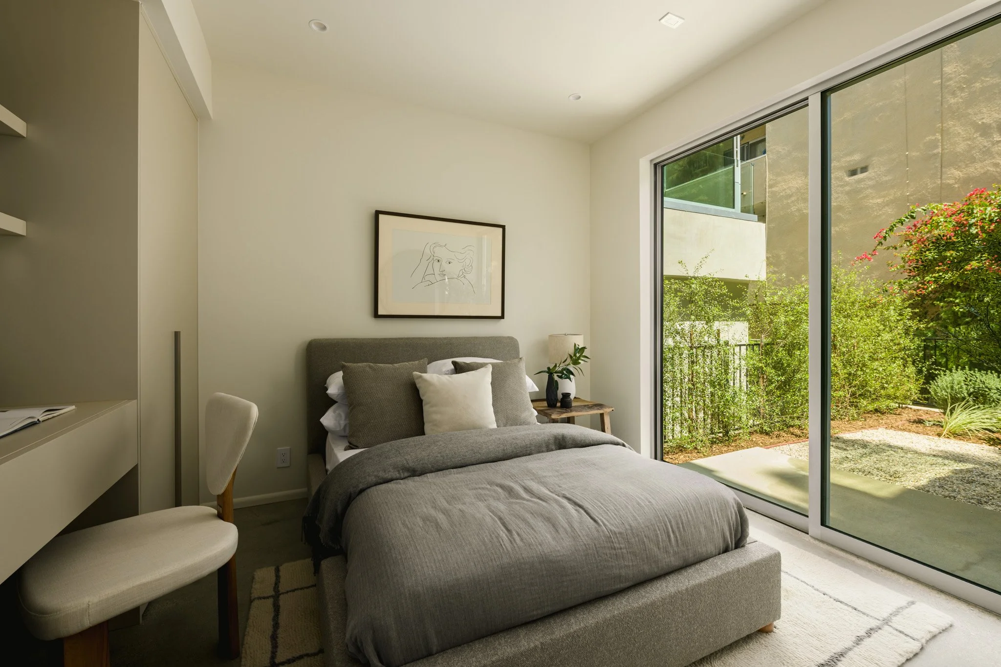 Secondary bedroom with floor-to-ceiling sliding glass doors, contemporary finishes, and abundant natural light, completed by JBurton General Contractor for new construction townhomes in Silver Lake, Los Angeles.