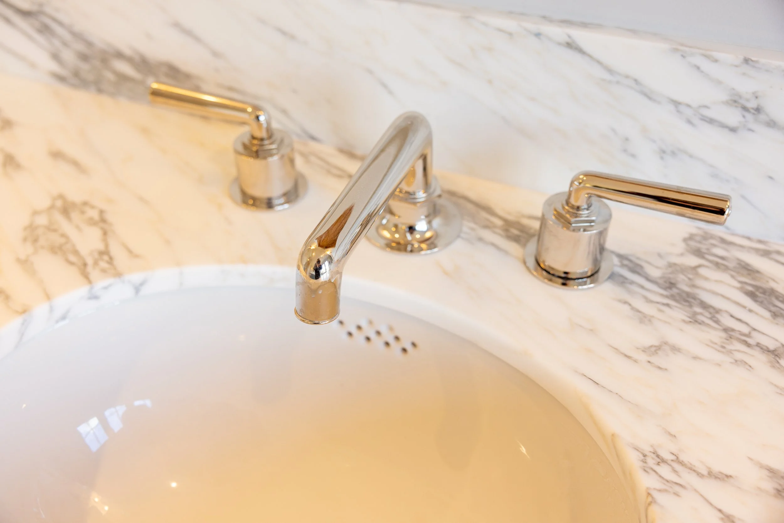 Elegant guest bathroom featuring marble countertops, subway tile walls, and timeless finishes, renovated by JBurton General Contractor in Hancock Park, Los Angeles.